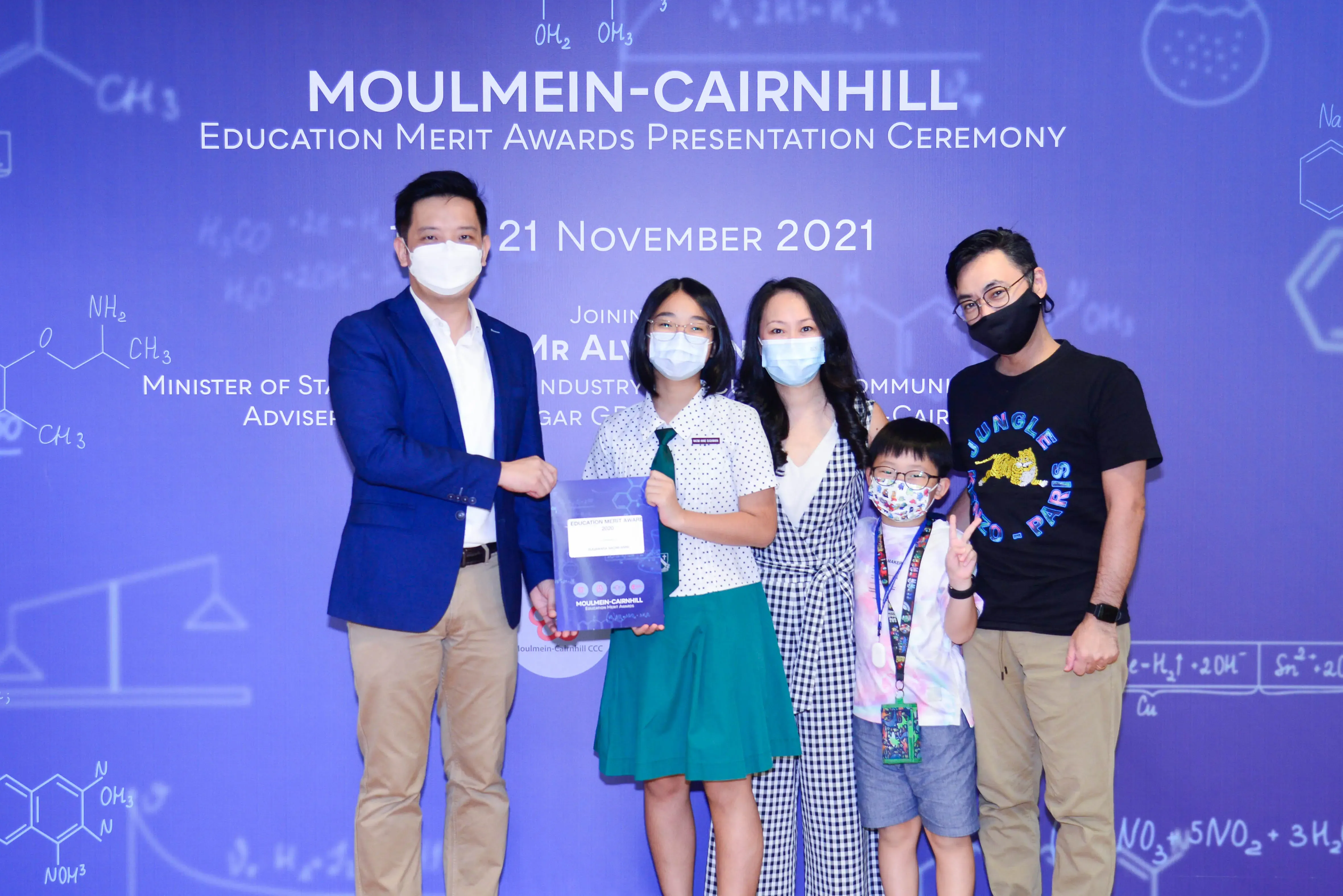 Five masked people pose at the Moulmein-Cairnhill Education Merit Awards Presentation Ceremony on 21 November 2021.