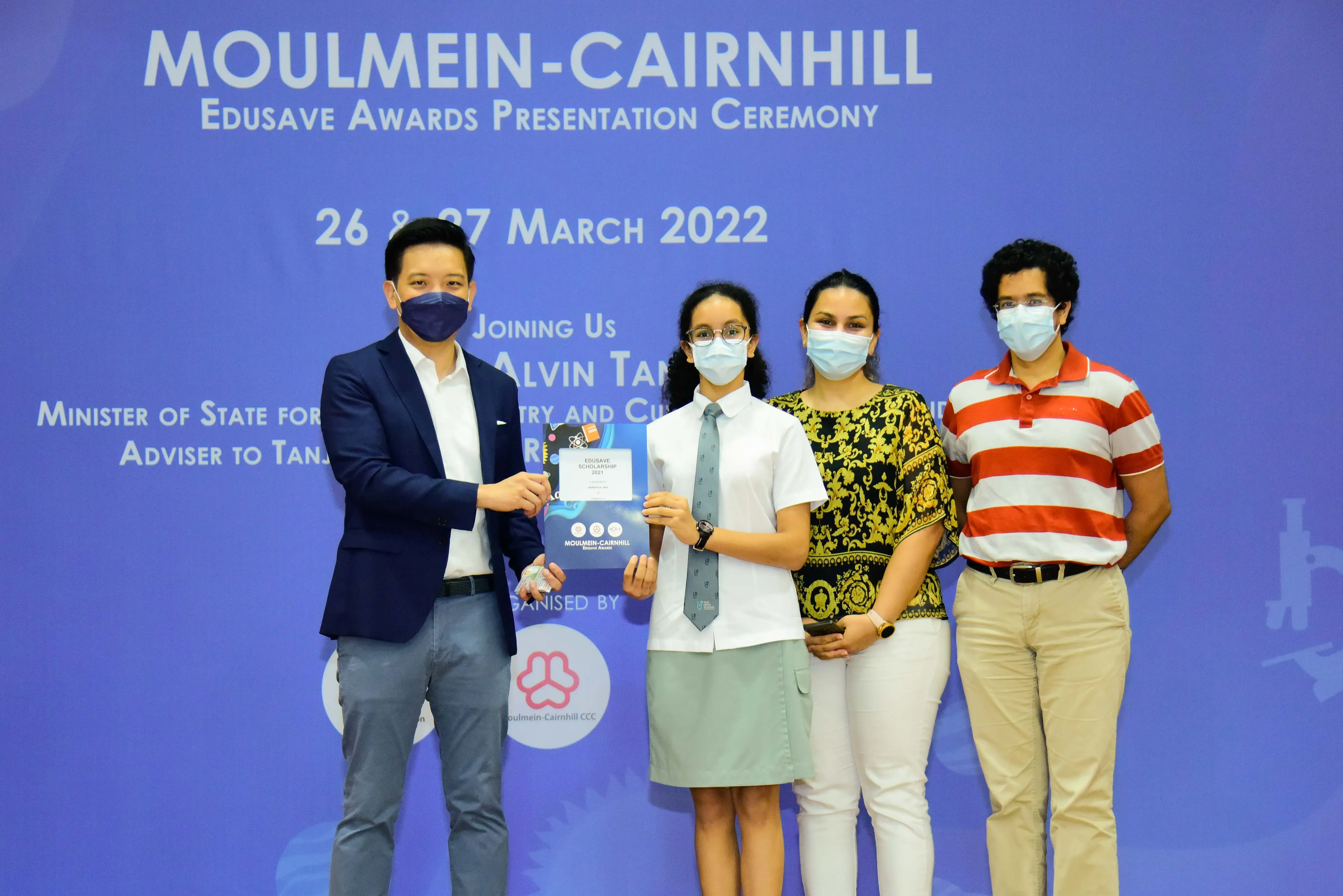 Four masked people pose at the Moulmein-Cairnhill Edusave Awards Presentation Ceremony on March 26-27, 2022.