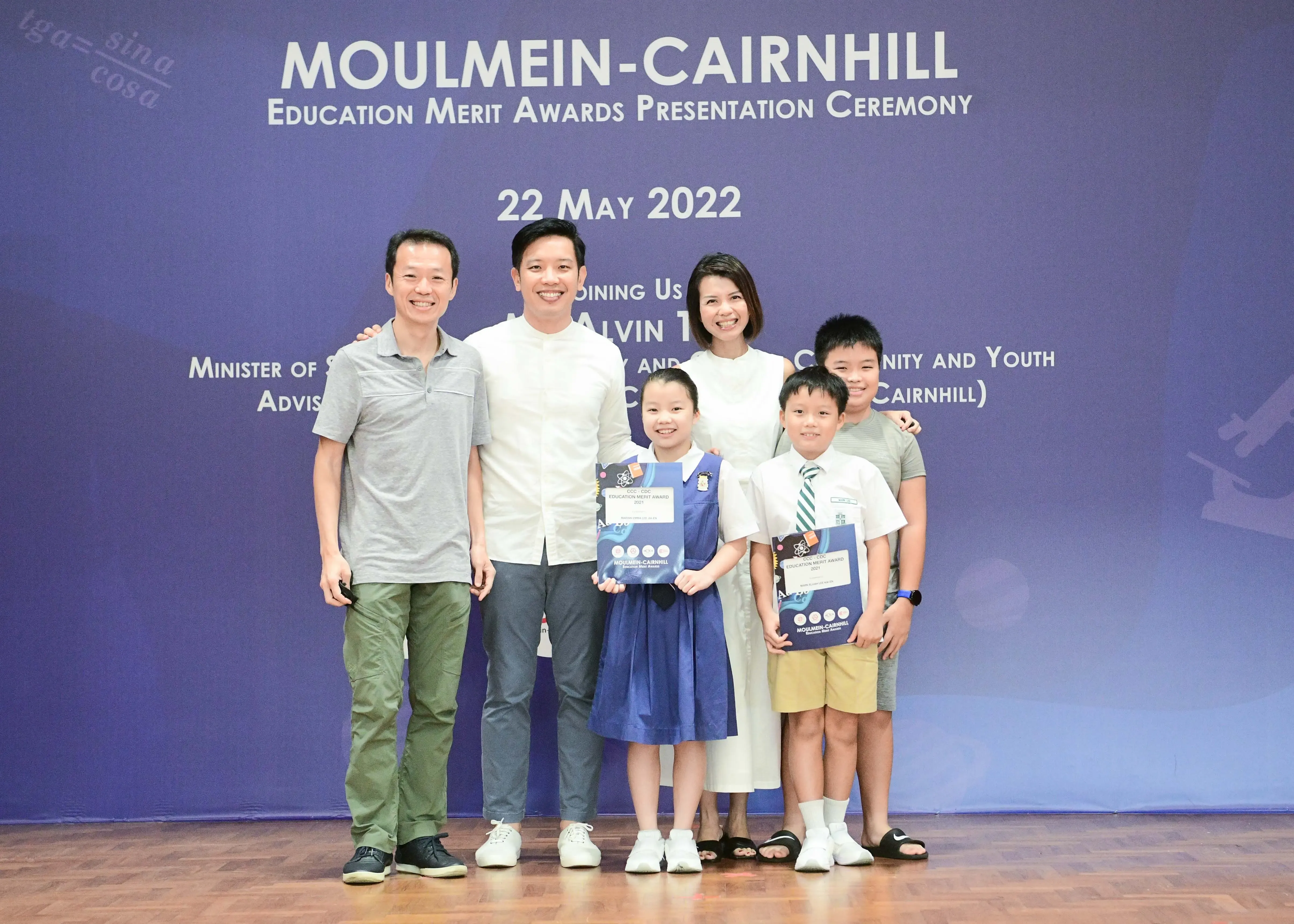 Three adults and three children pose at the Moulmein-Cairnhill Education Merit Awards Ceremony on 22 May 2022.