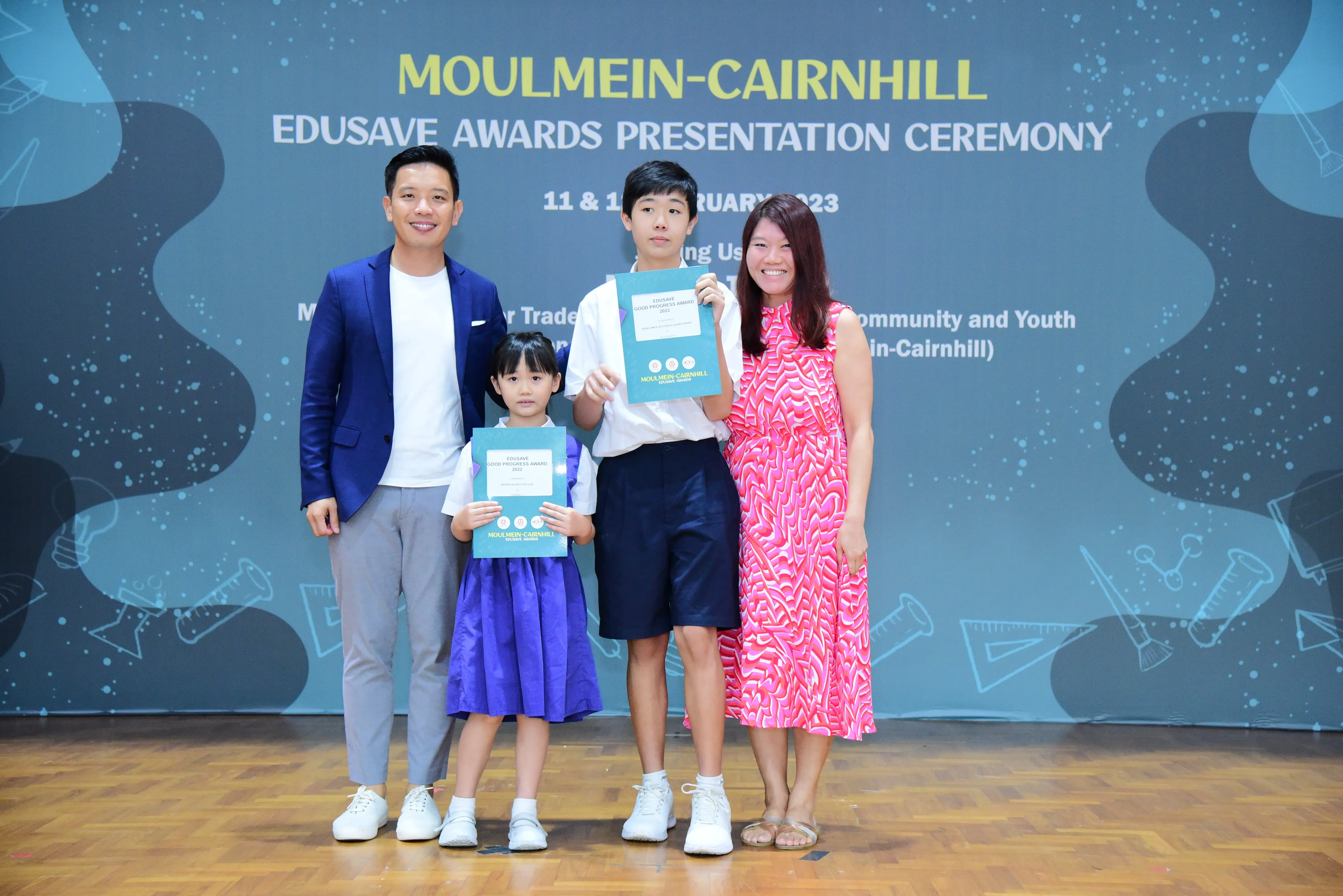 Four people pose with award certificates at the Moulmein-Cairnhill Edusave Awards Presentation Ceremony 2023.