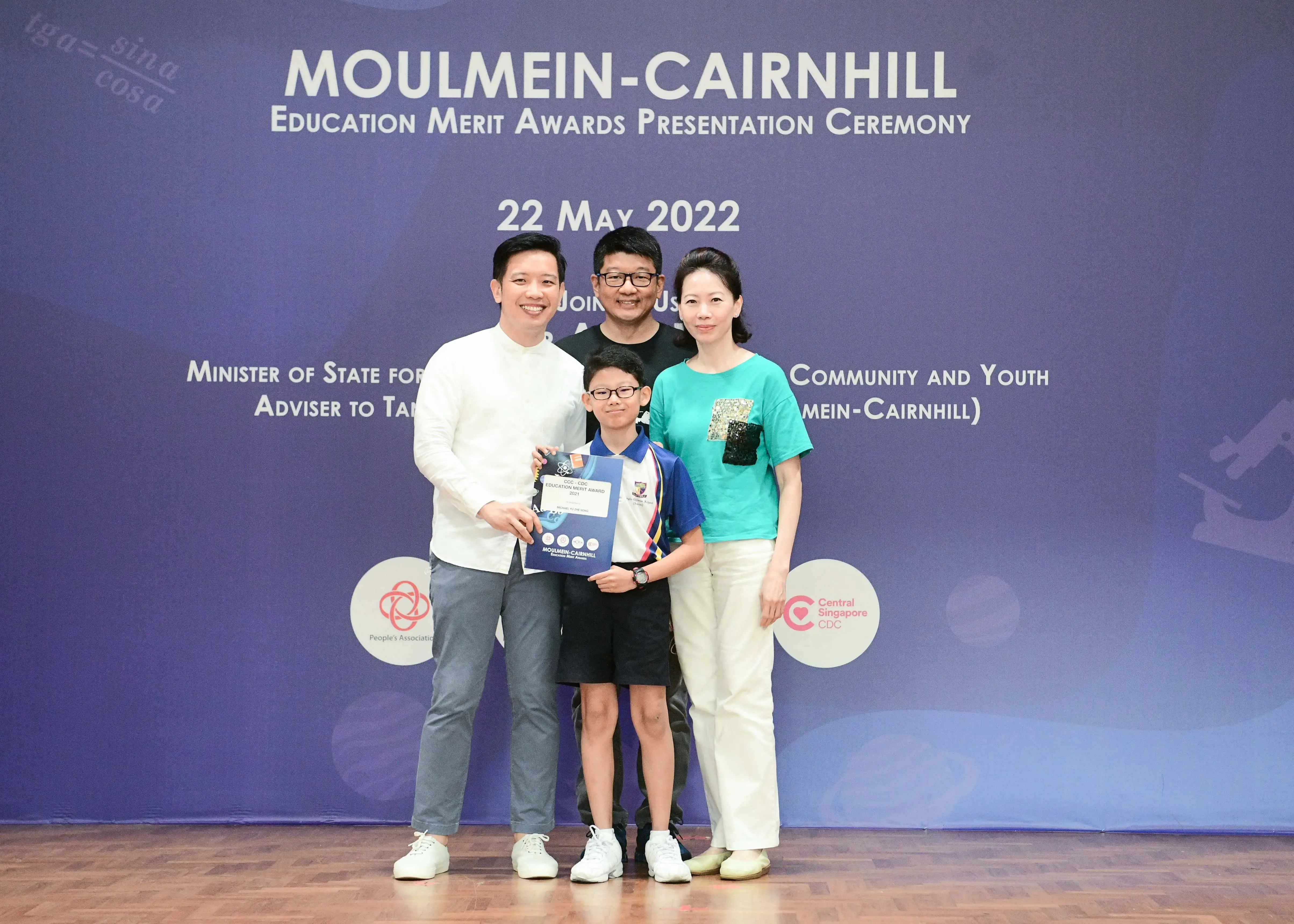 Four people pose together at the Moulmein-Cairnhill Education Merit Awards Presentation Ceremony on 22 May 2022.
