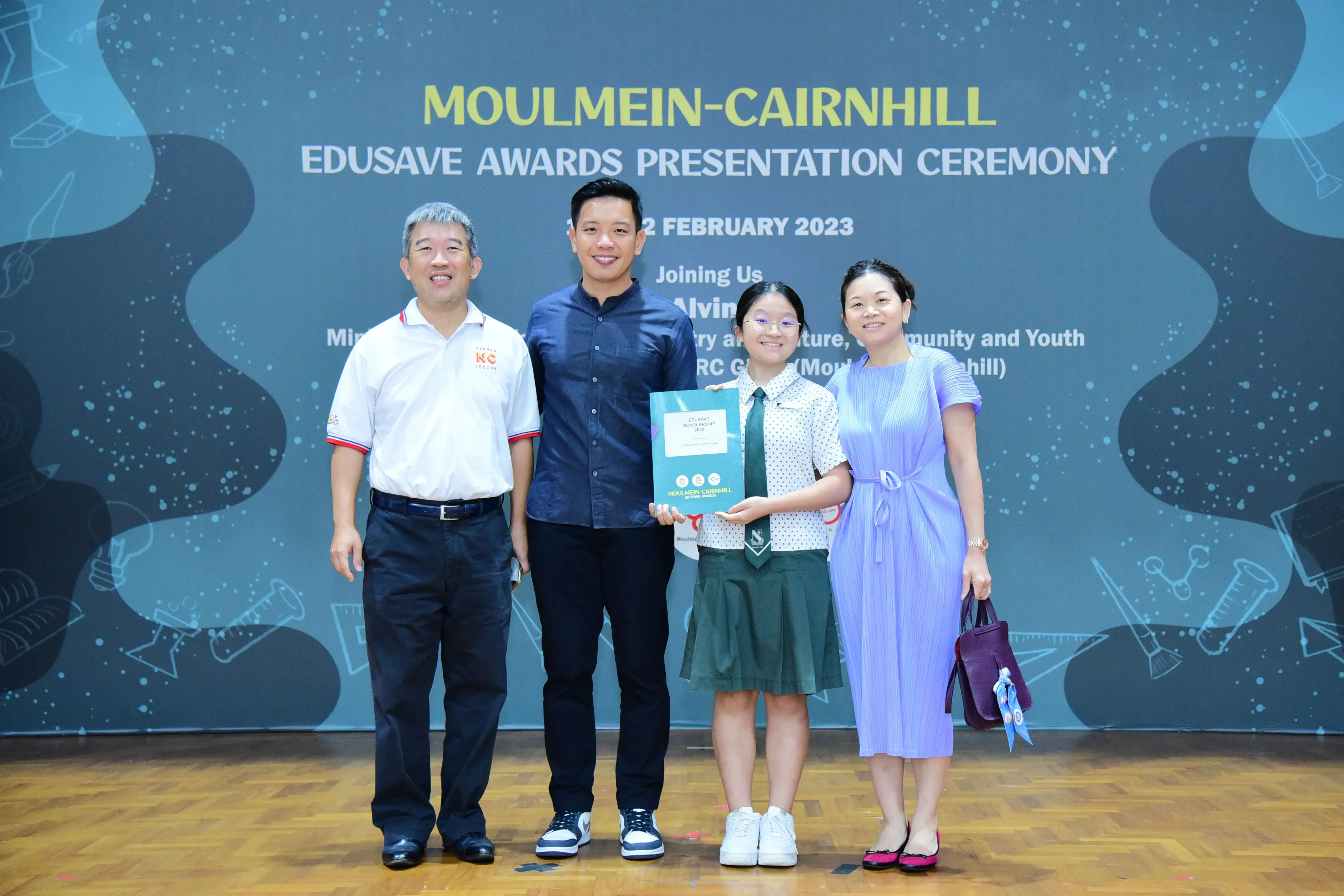 Four people pose at the Moulmein-Cairnhill Edusave Awards Presentation Ceremony on 2 February 2023.