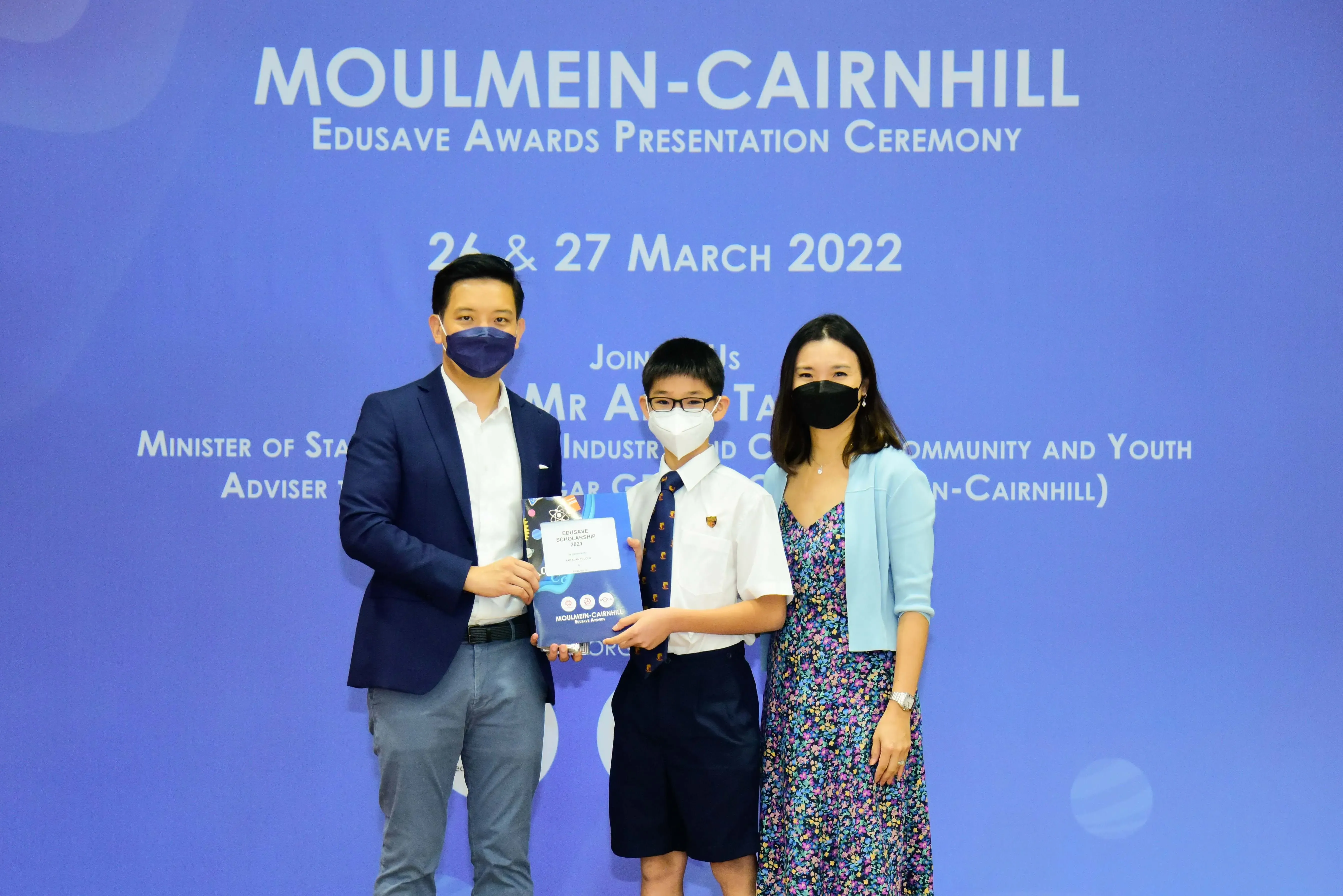 Three masked people pose at the Moulmein-Cairnhill Edusave Awards Presentation Ceremony on 26-27 March 2022.