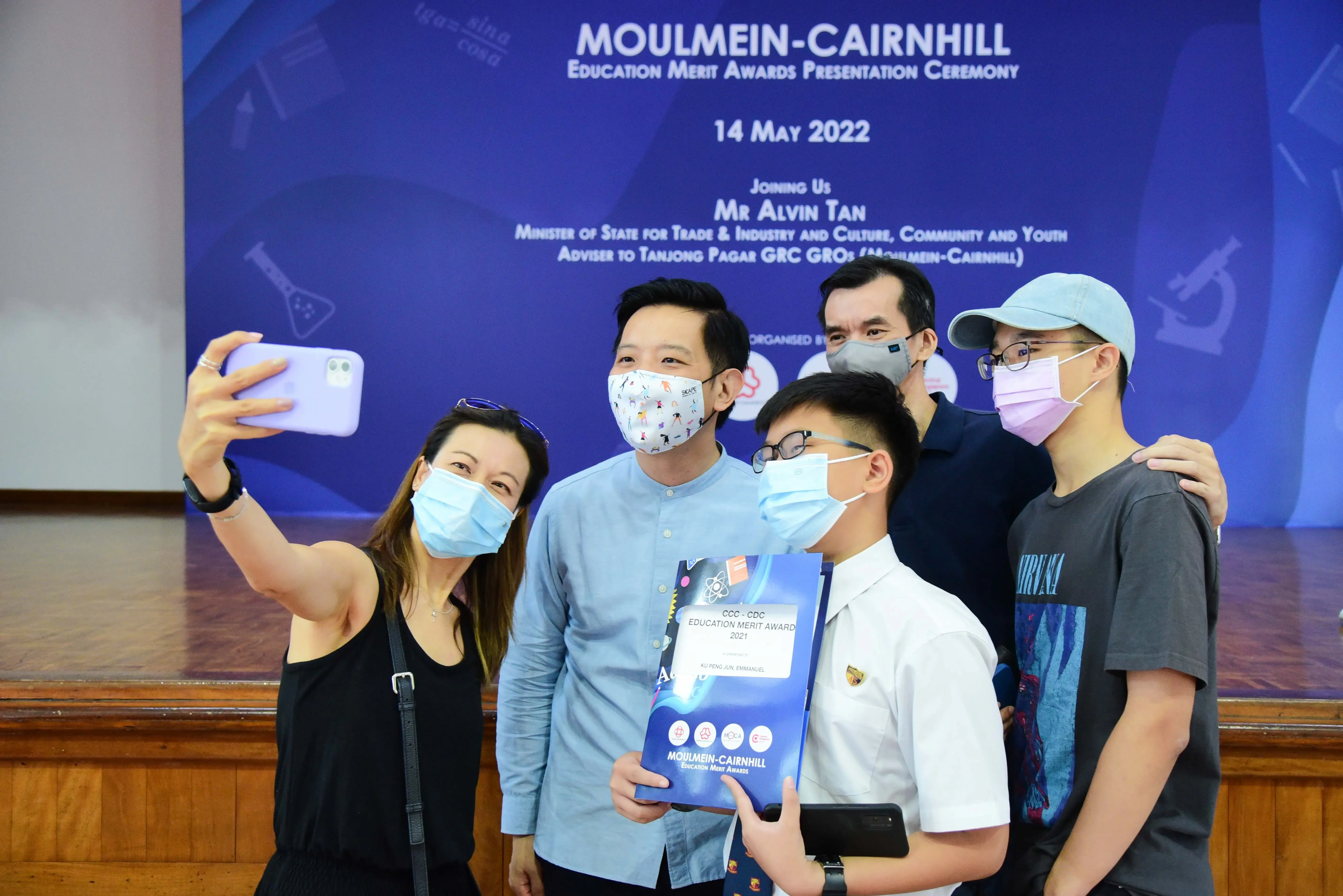 Five masked people take a selfie at the Moulmein-Cairnhill Education Merit Awards Ceremony on 14 May 2022.