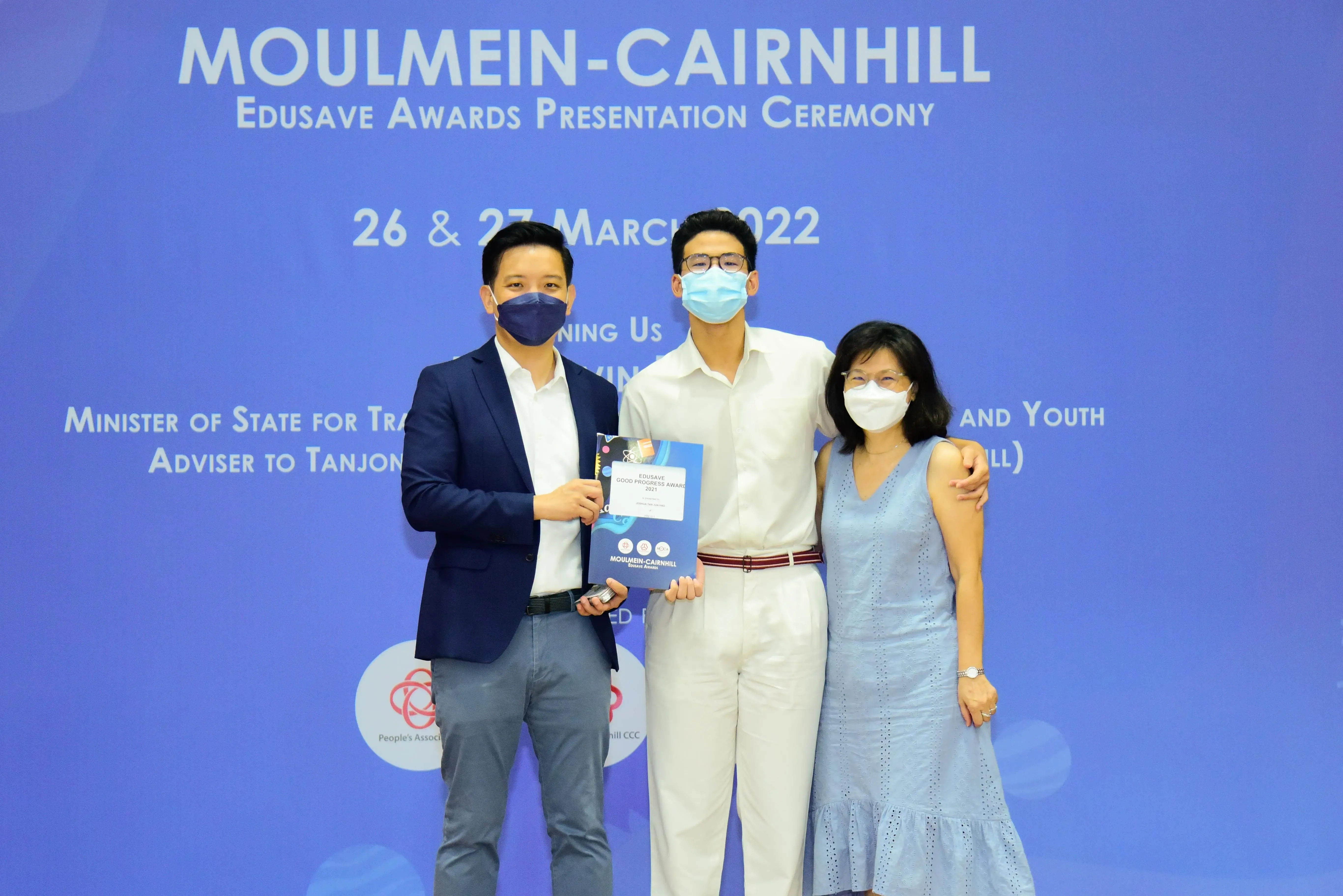 Three masked people pose at the Moulmein-Cairnhill Edusave Awards Presentation Ceremony on 26-27 March 2022.