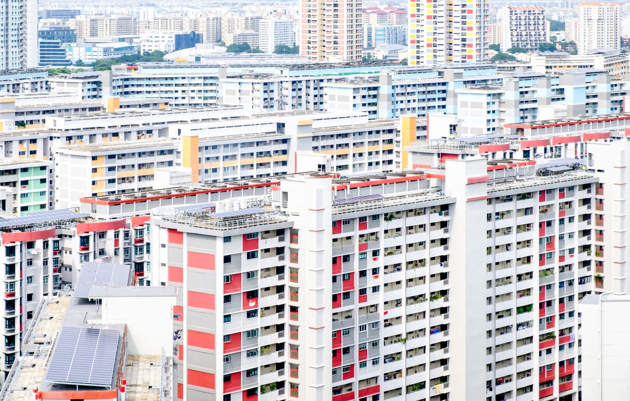 Aerial view of densely packed colorful residential apartment blocks with red, yellow, and blue accents.