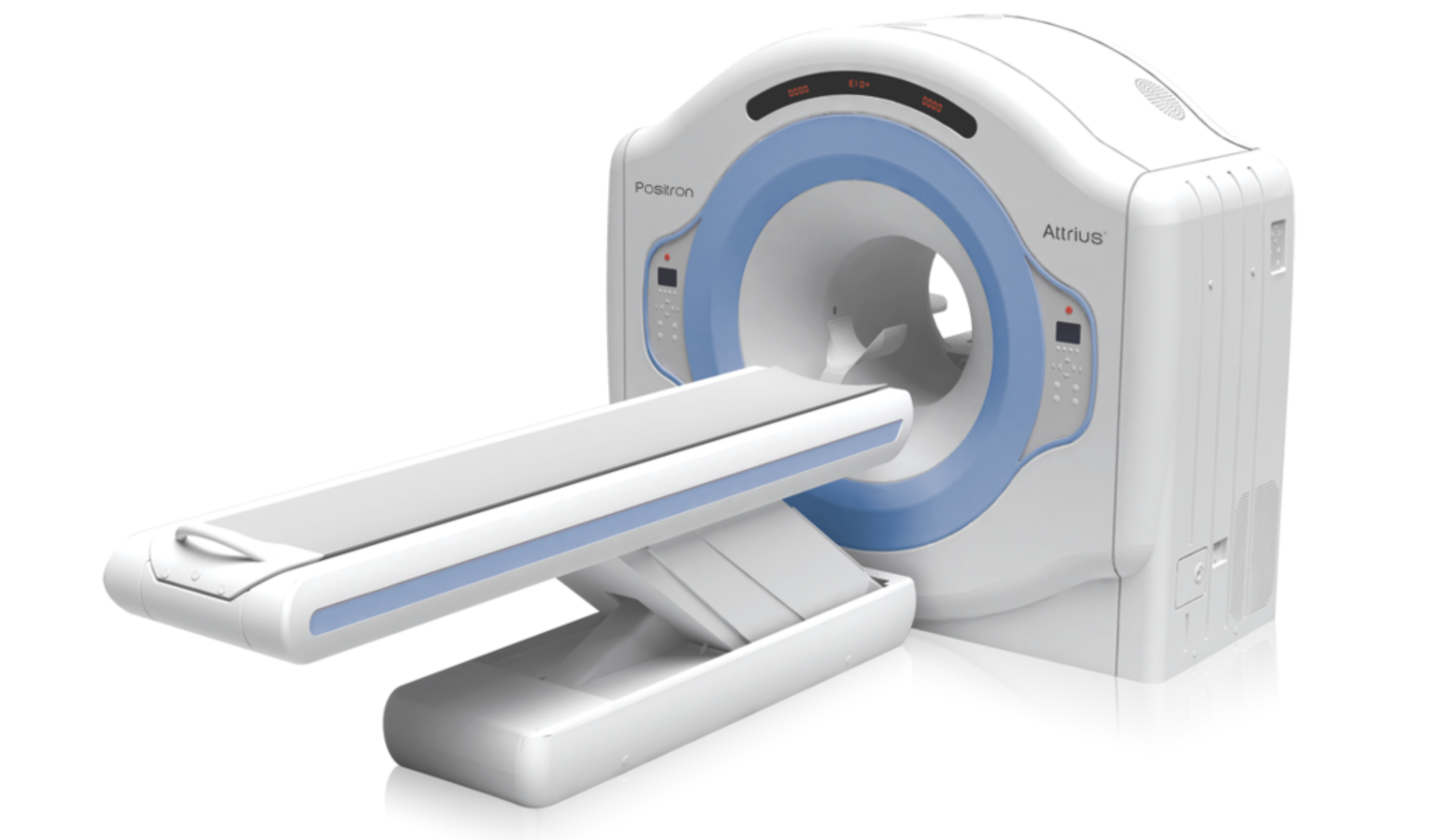 White and blue Positron Attrius medical CT scanner with a circular gantry and sliding patient table.
