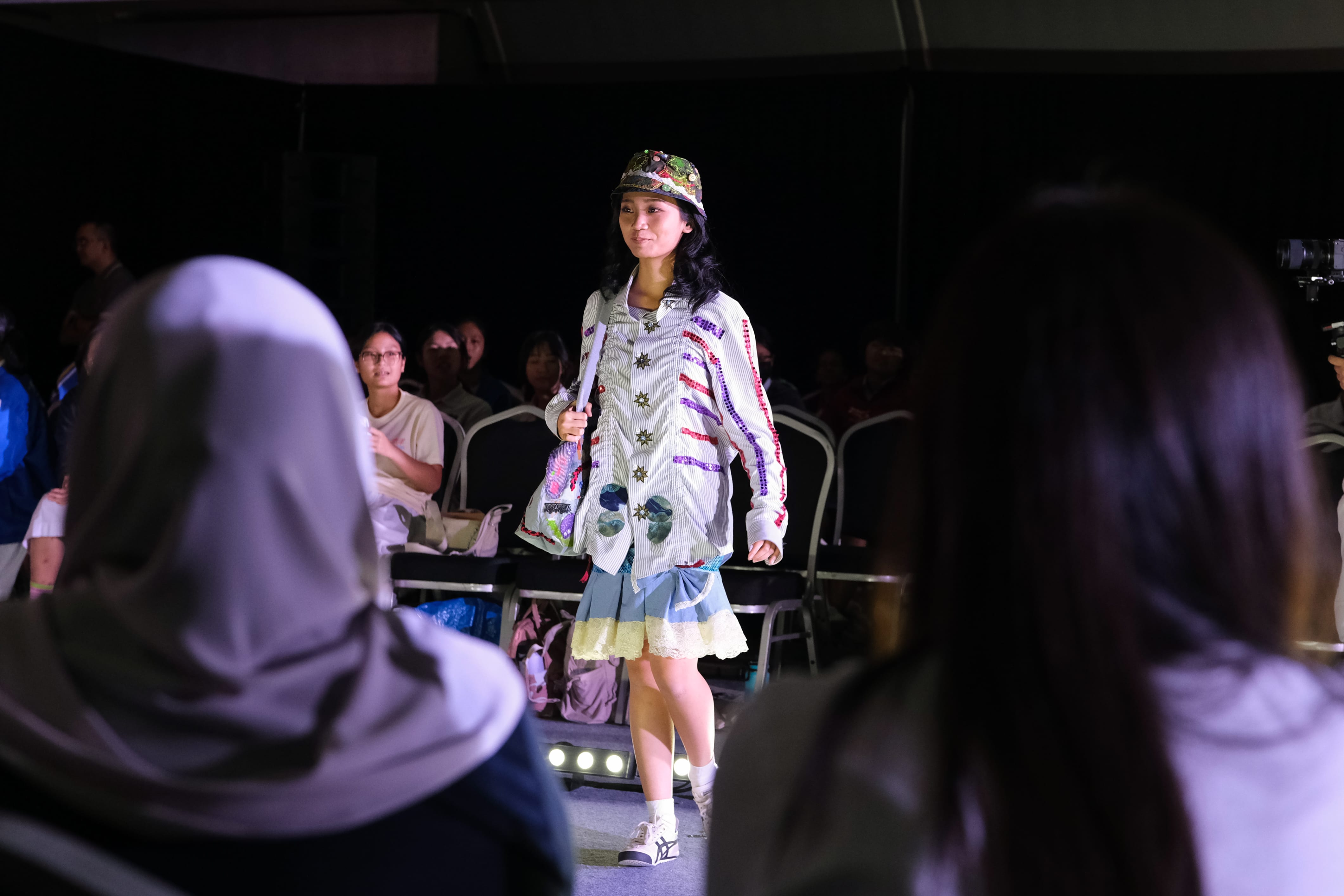 Model on the runway in colourful clothes made of recycled materials