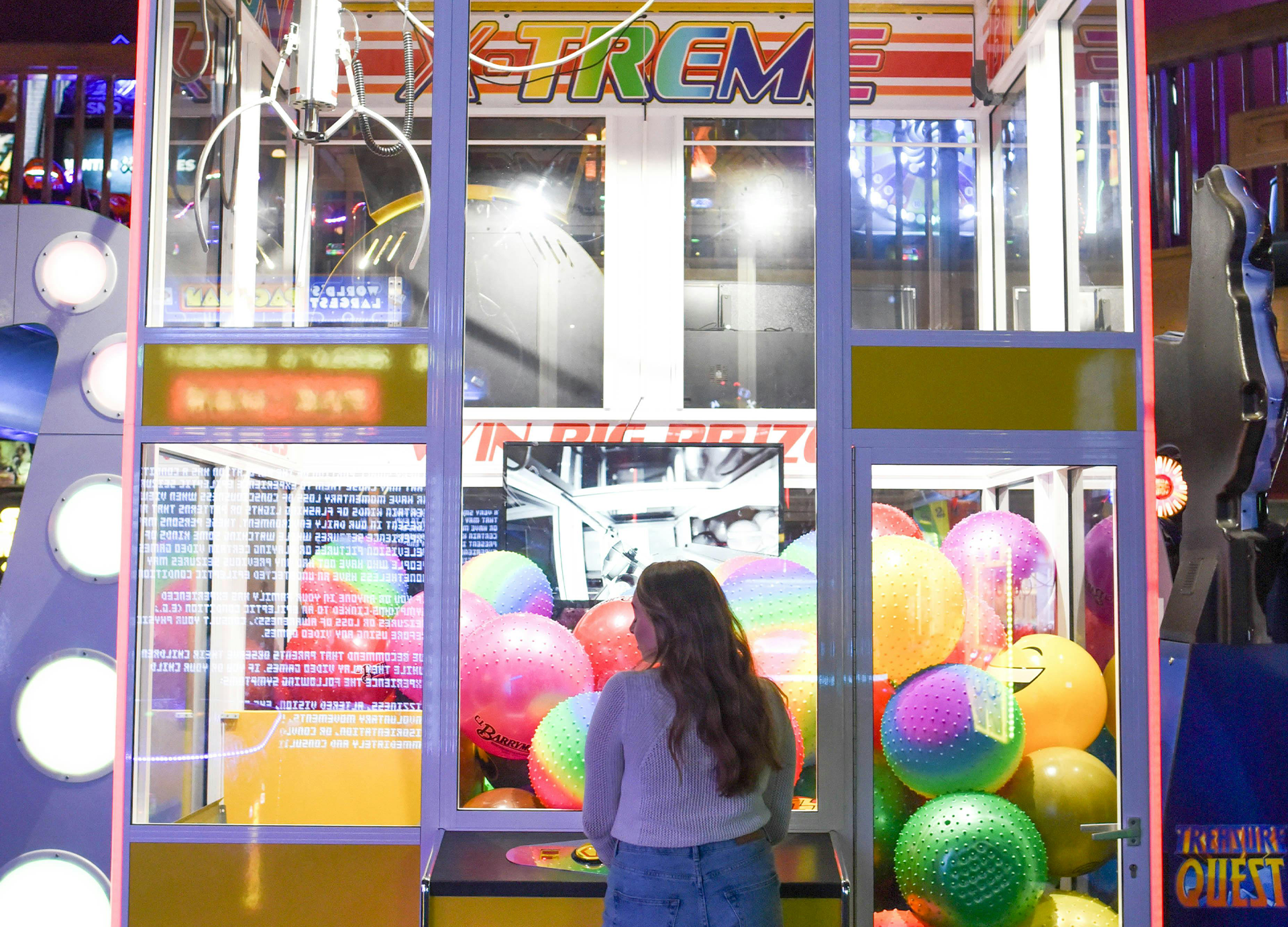 Girl playing at a claw machine