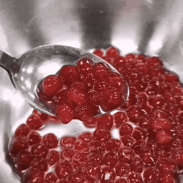 GIF of spoon scooping boba pearls