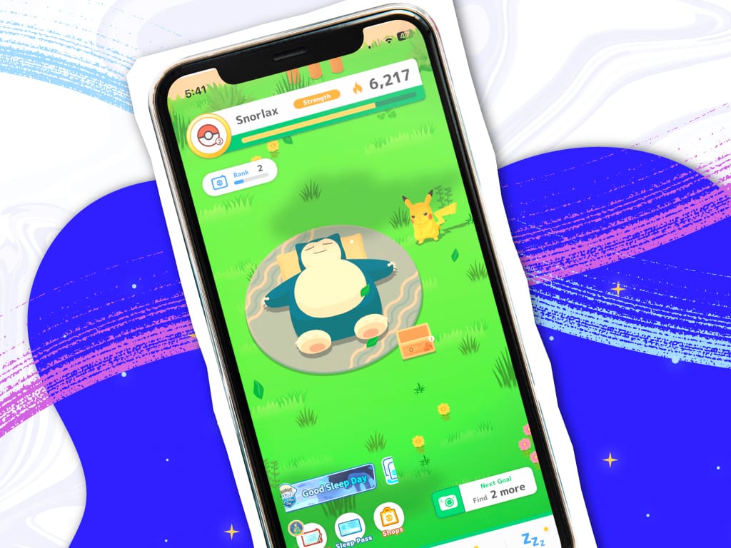 Smartphone showing Pokemon Sleep app with Snorlax sleeping on grass and Pikachu nearby, strength score 6,217.