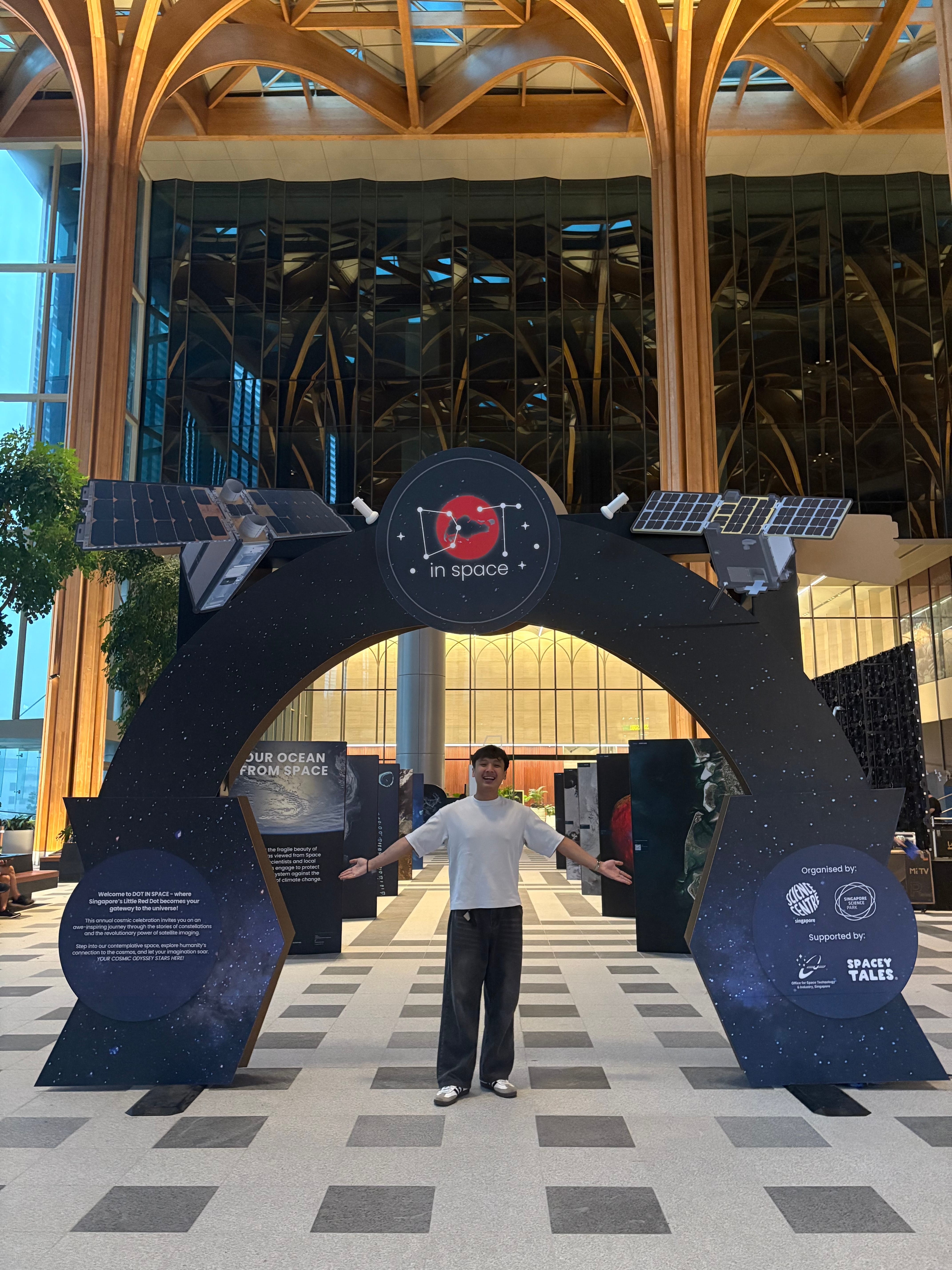 Jarrod Chua in front of the Dot in Space exhibition