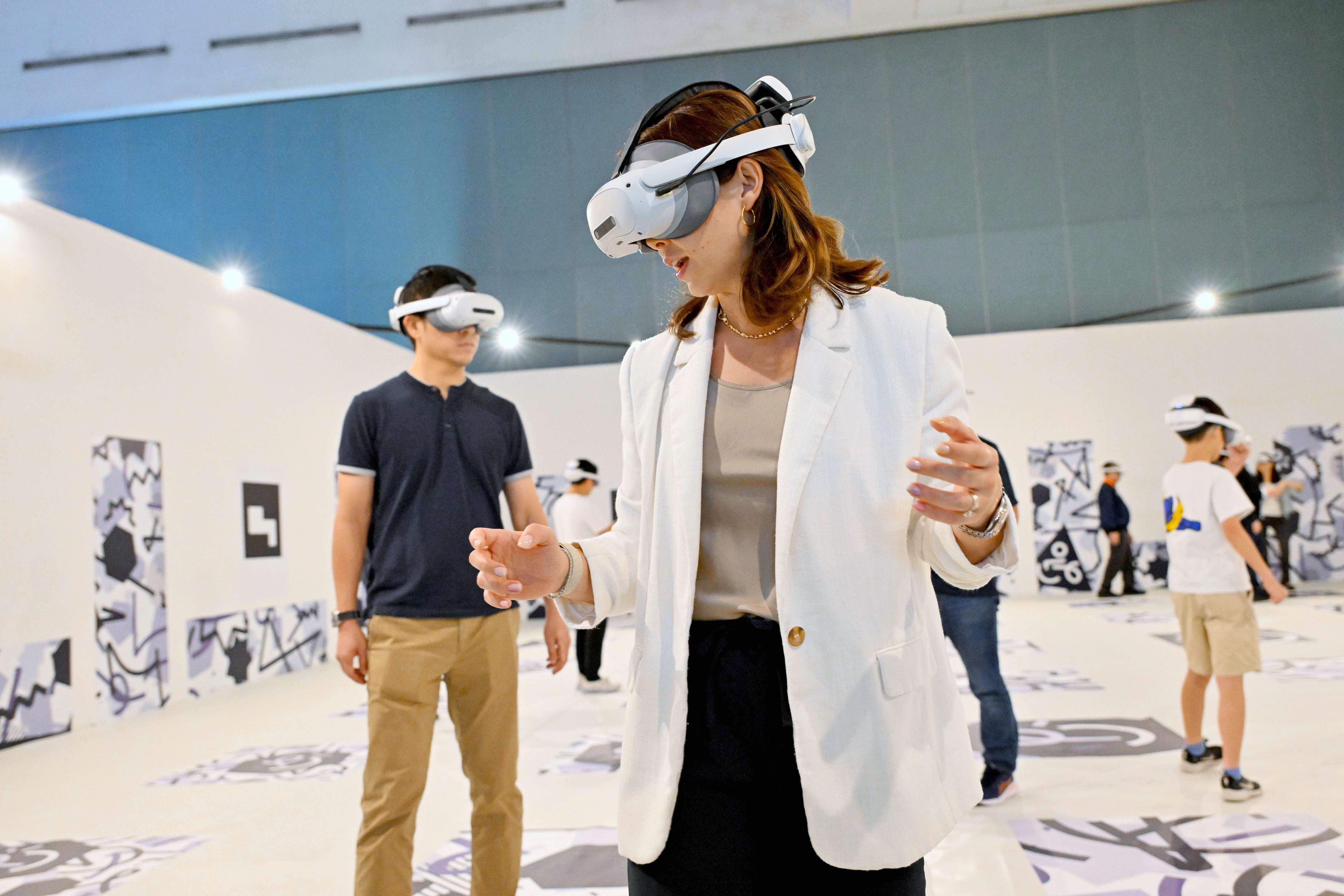 Photograph of visitors immersed in the VR experience