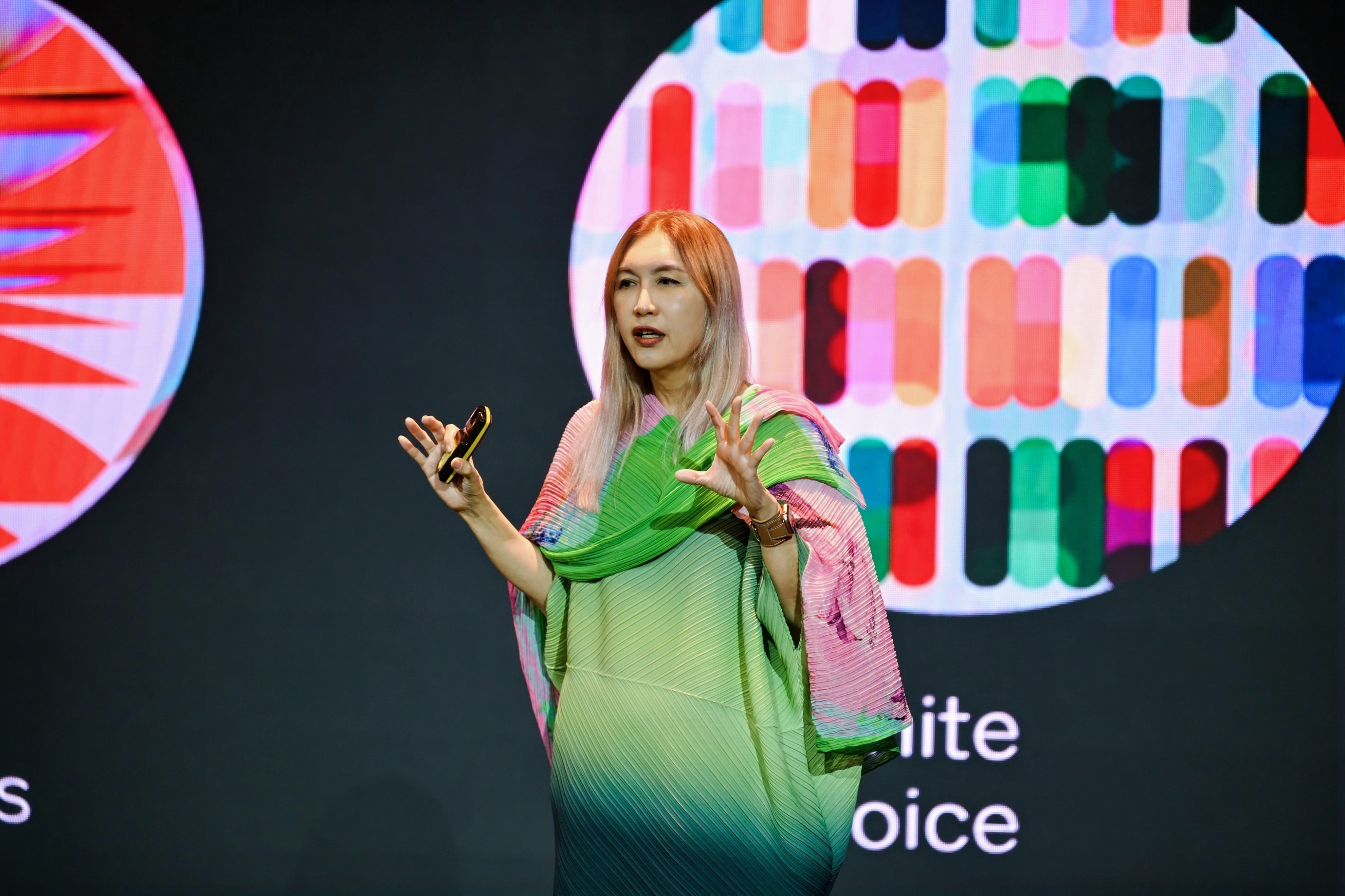 A female speaker speaking on stage.
