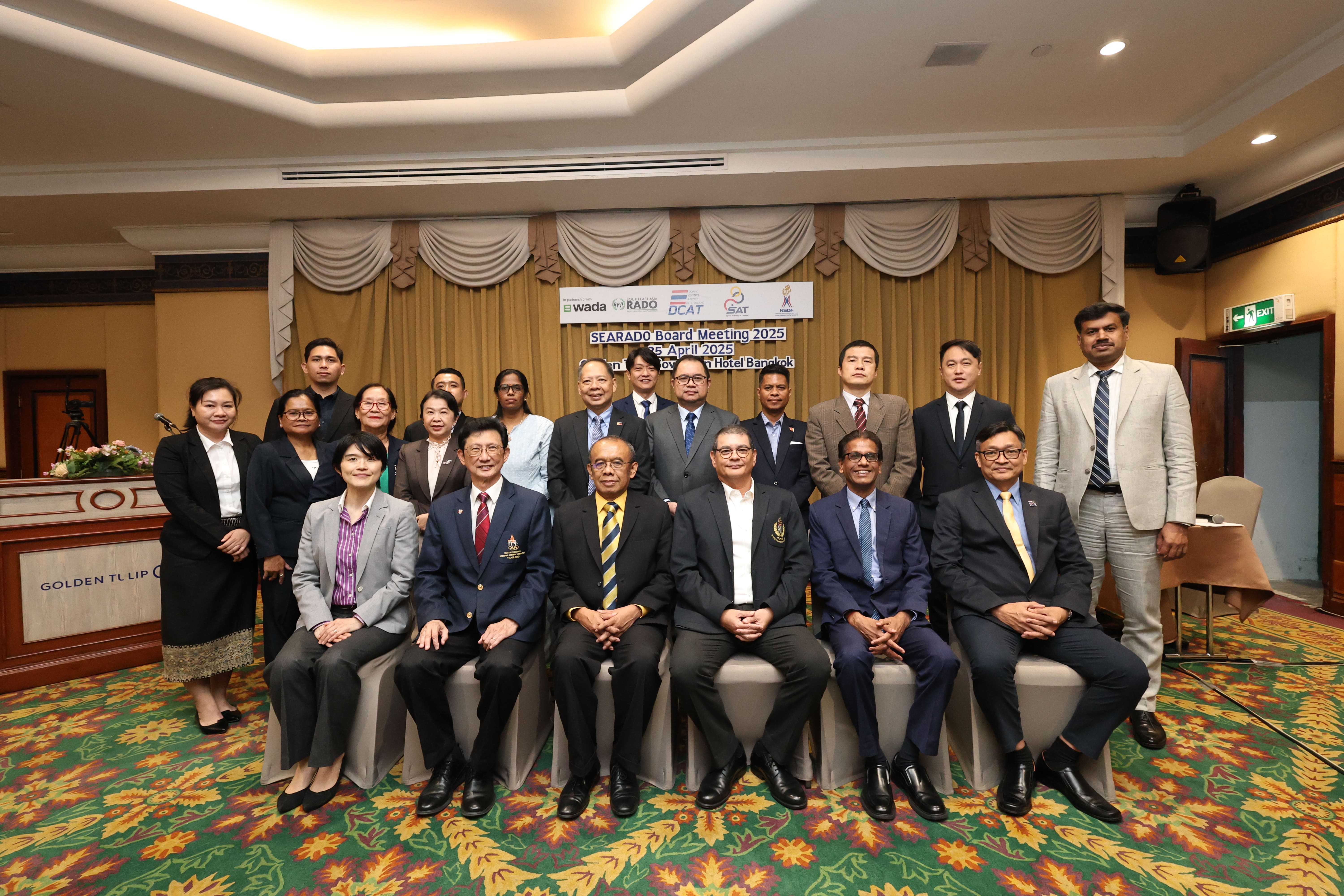 Group of about 20 people posing at SEARADO Board Meeting 2025, April 25, Bangkok hotel conference room.