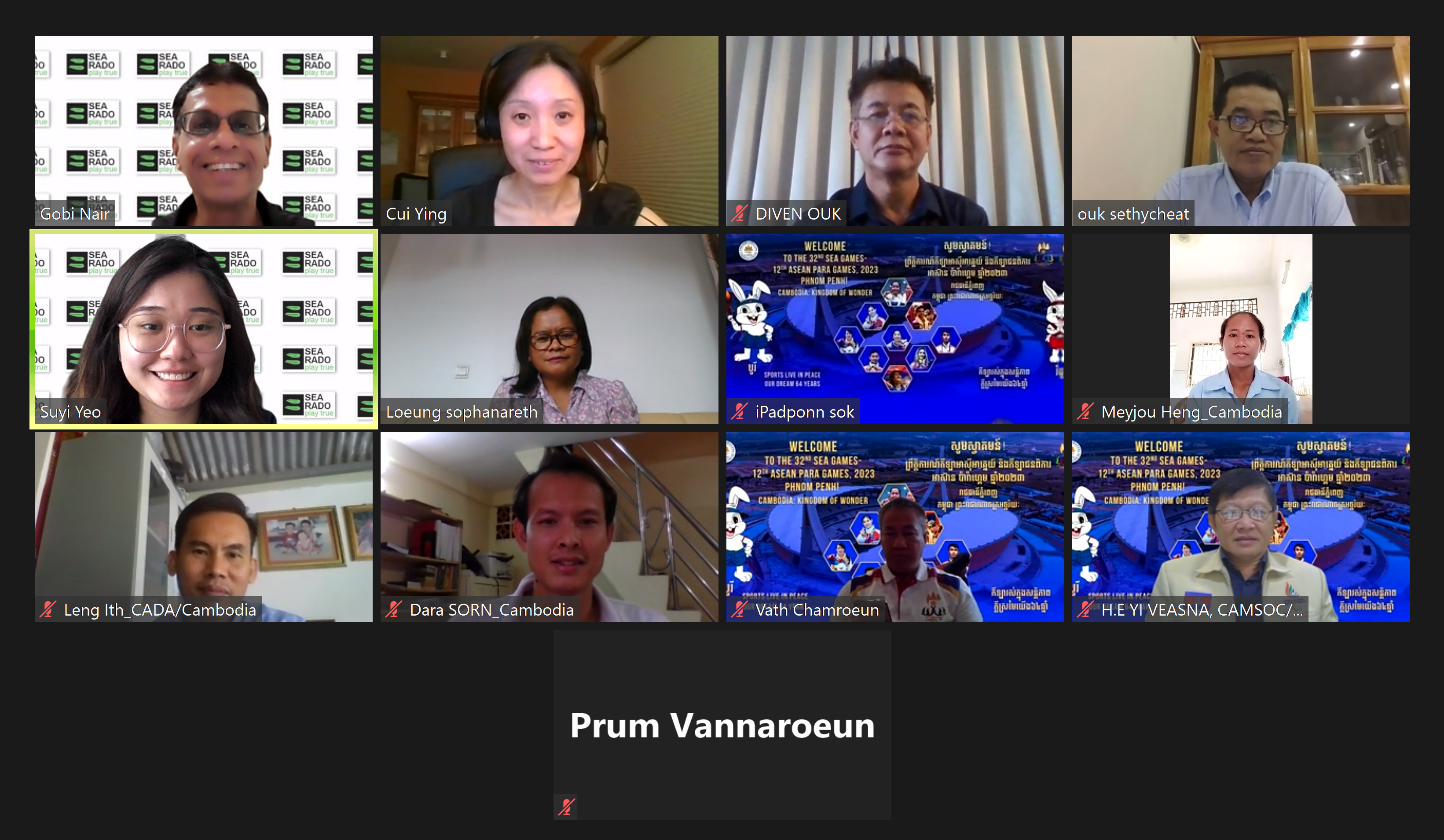 Grid of video call tiles with blurred faces, name labels, and a few SEA Games 2023 welcome slides.