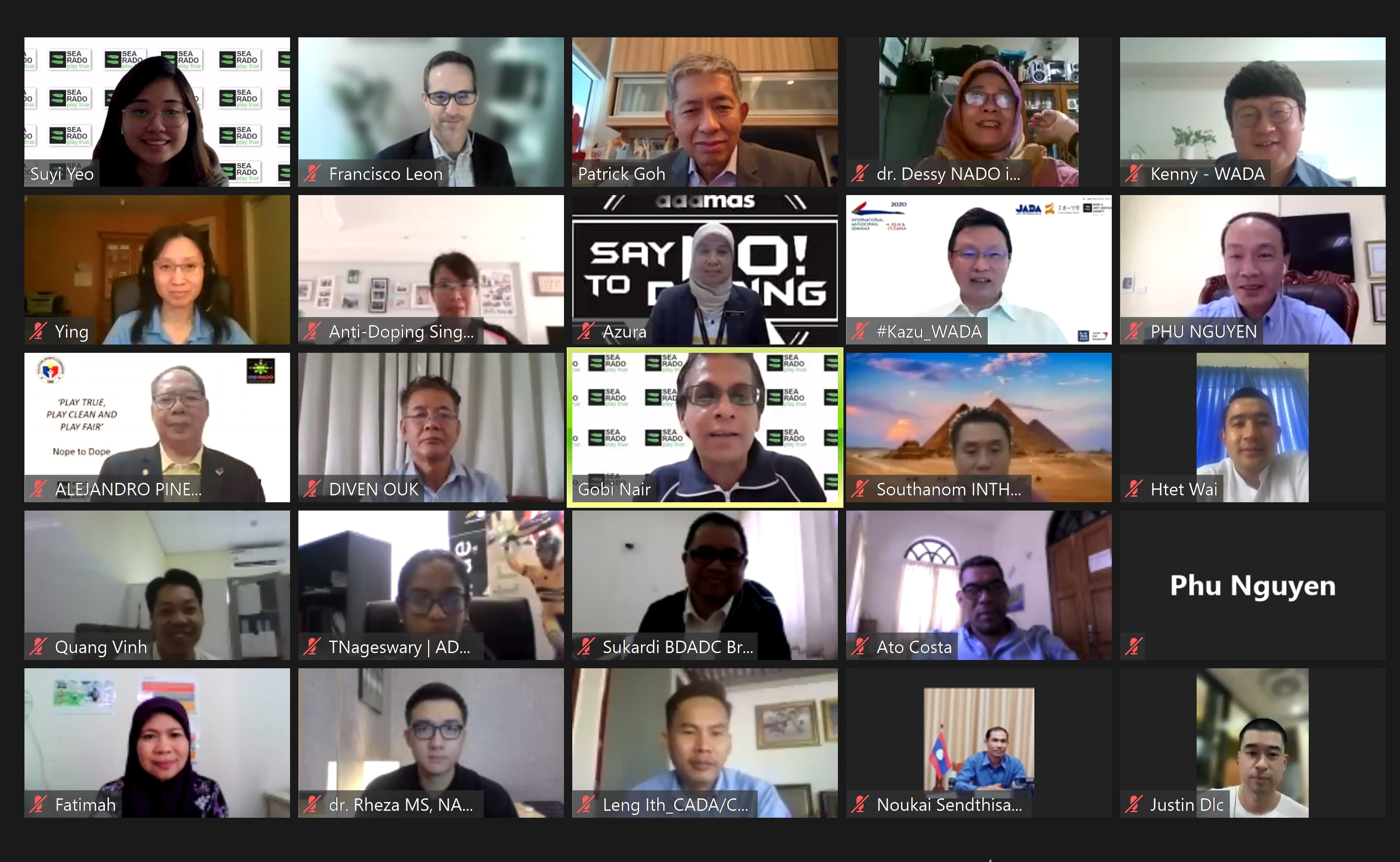 A video conference grid showing about 20 named participants, one tile displaying a "Say No to Doping" anti-doping banner.