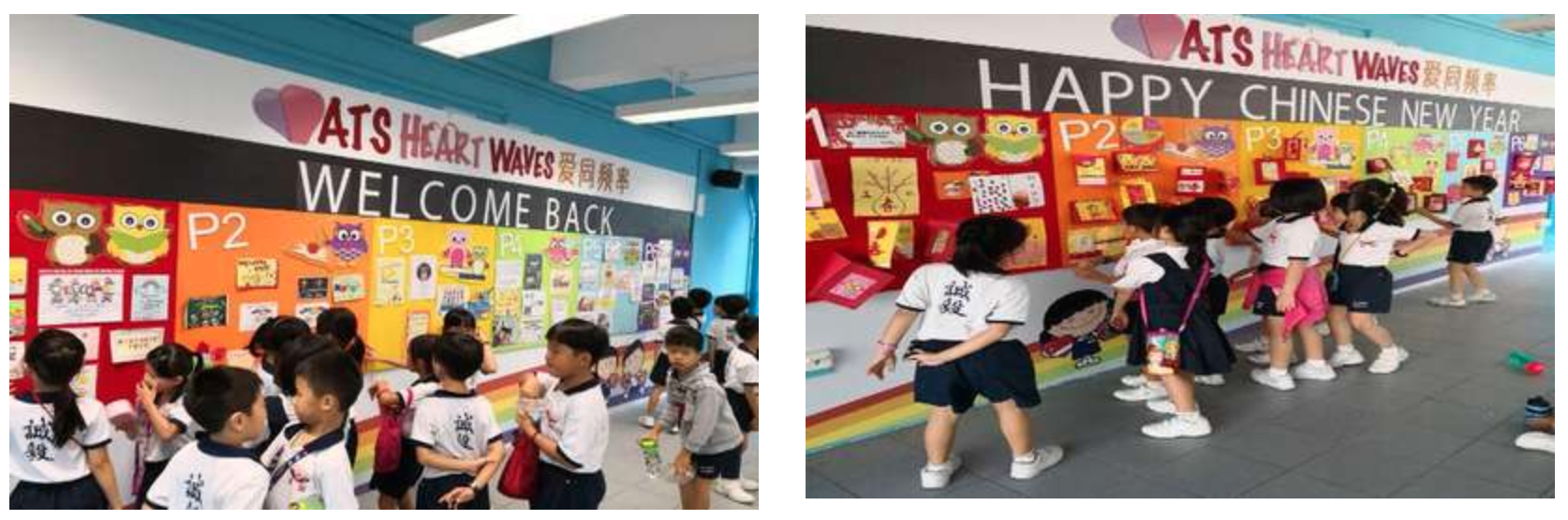 Young students in uniforms view colorful school bulletin boards reading "Welcome Back" and "Happy Chinese New Year."
