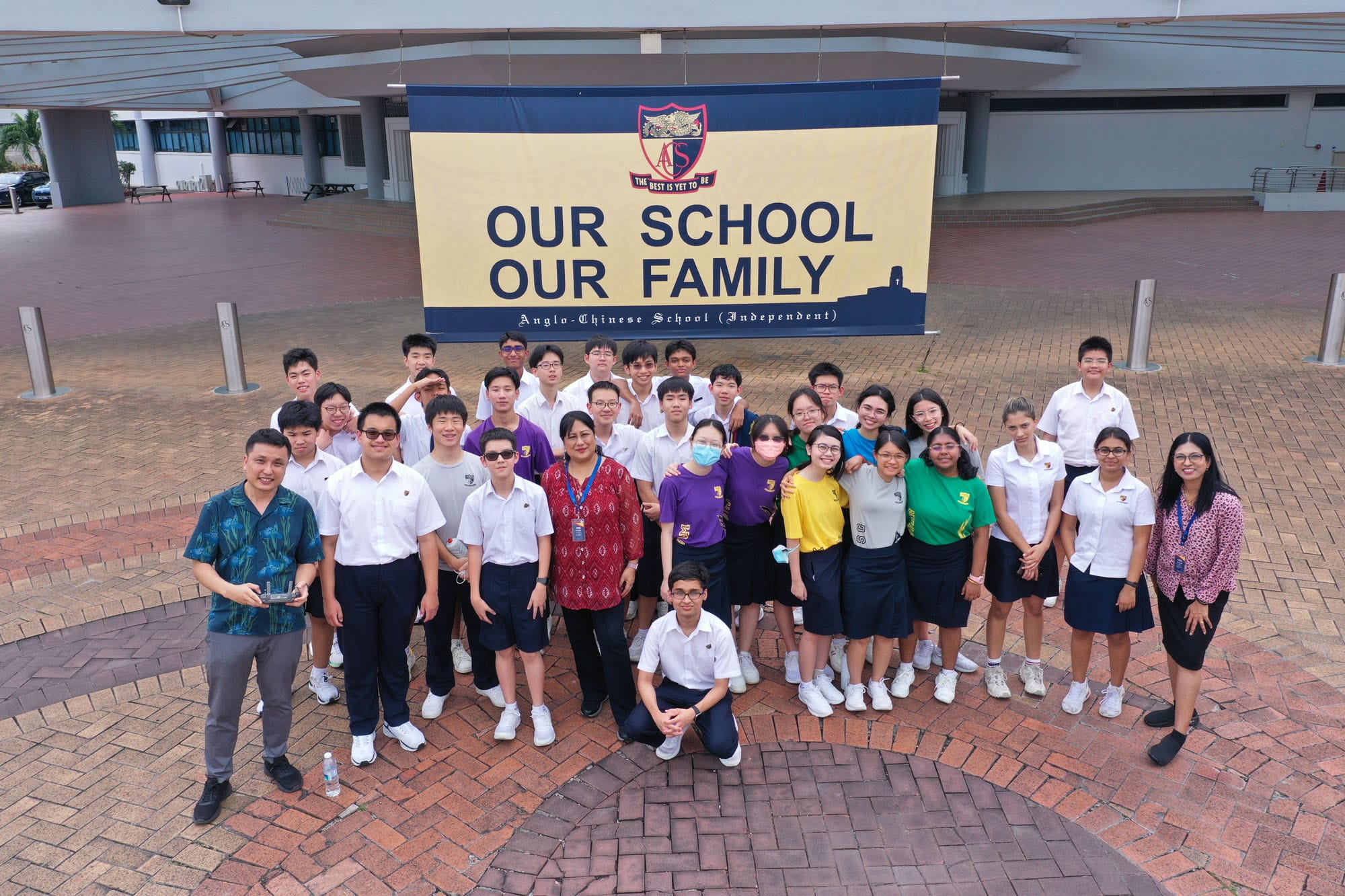A group of MPAC students and their teachers posing for an overhead drone shot