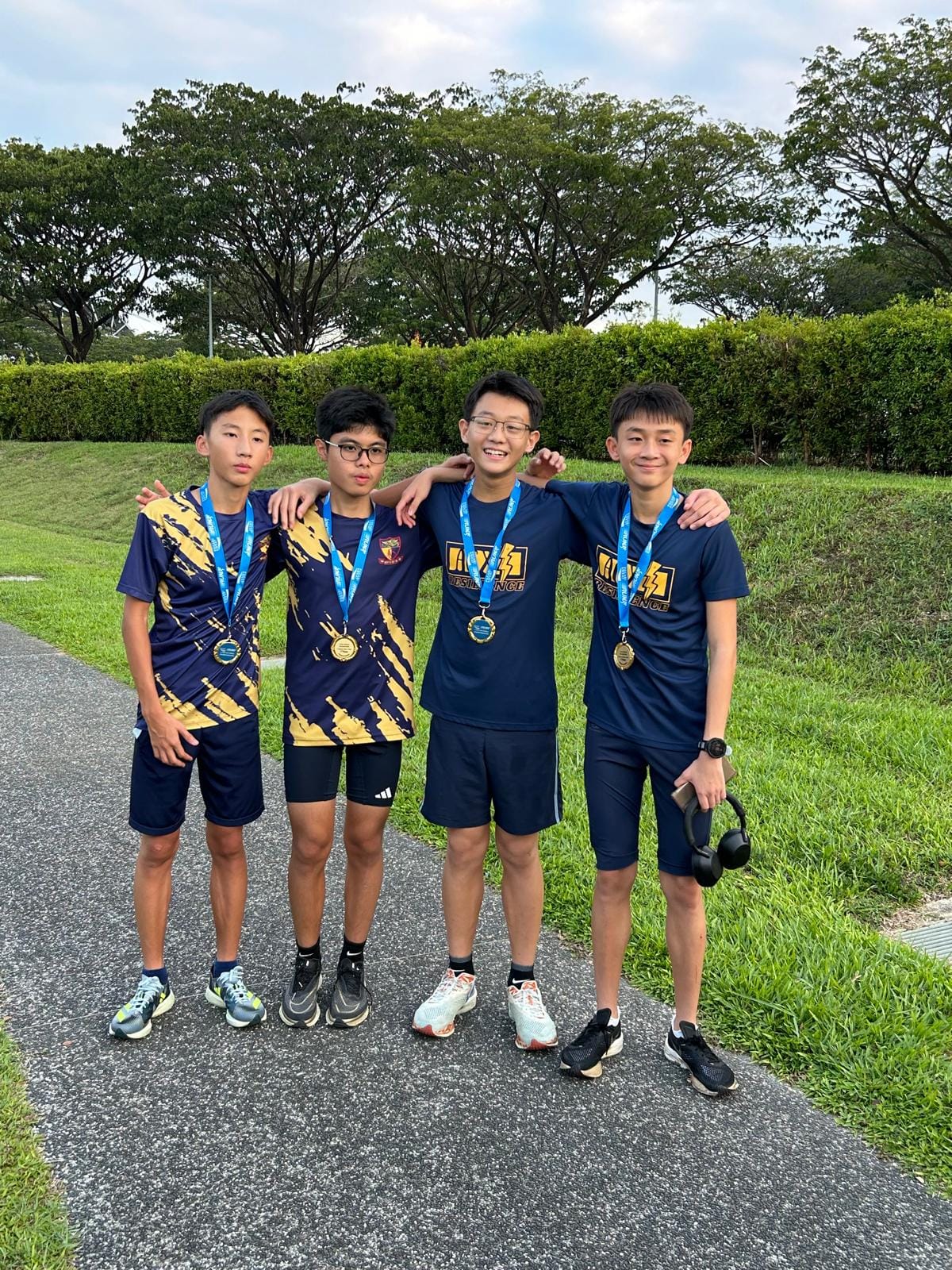 4 boys wearing medals