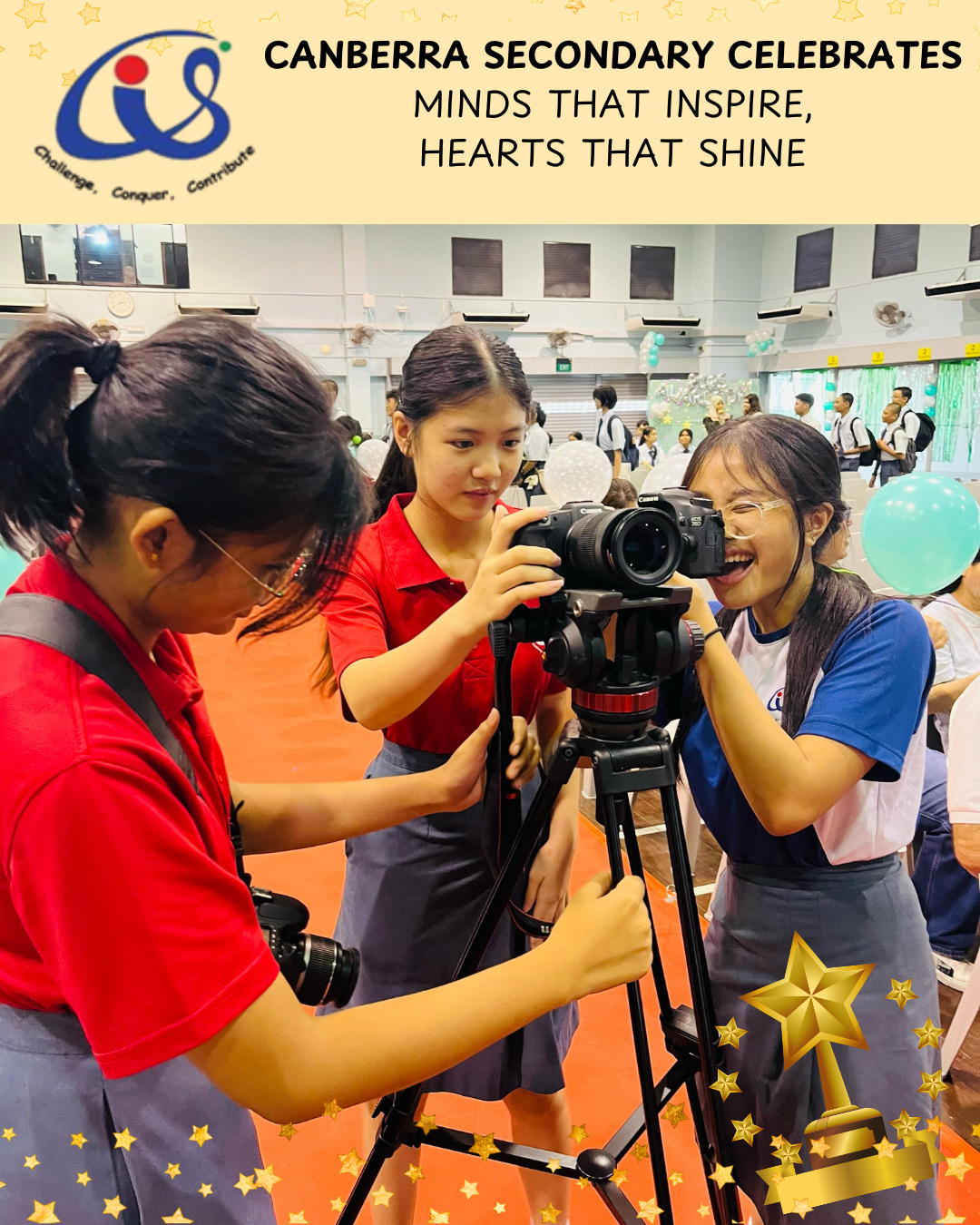 Students adjust a camera on a tripod