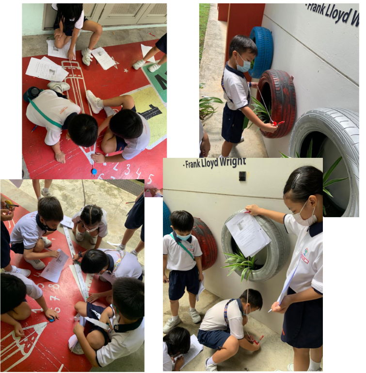Young students in school uniforms measure and observe tires used as planters and a painted floor outdoors.