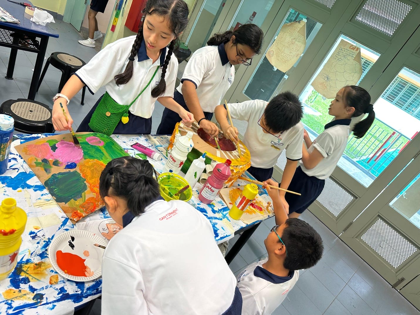 Several students painting in the art room.