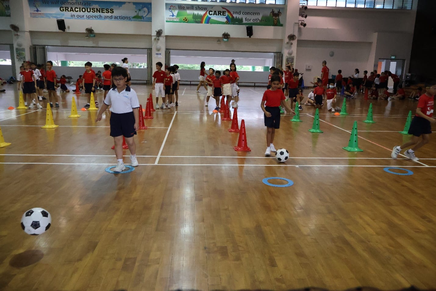 Students playing ball games during lower primary games day