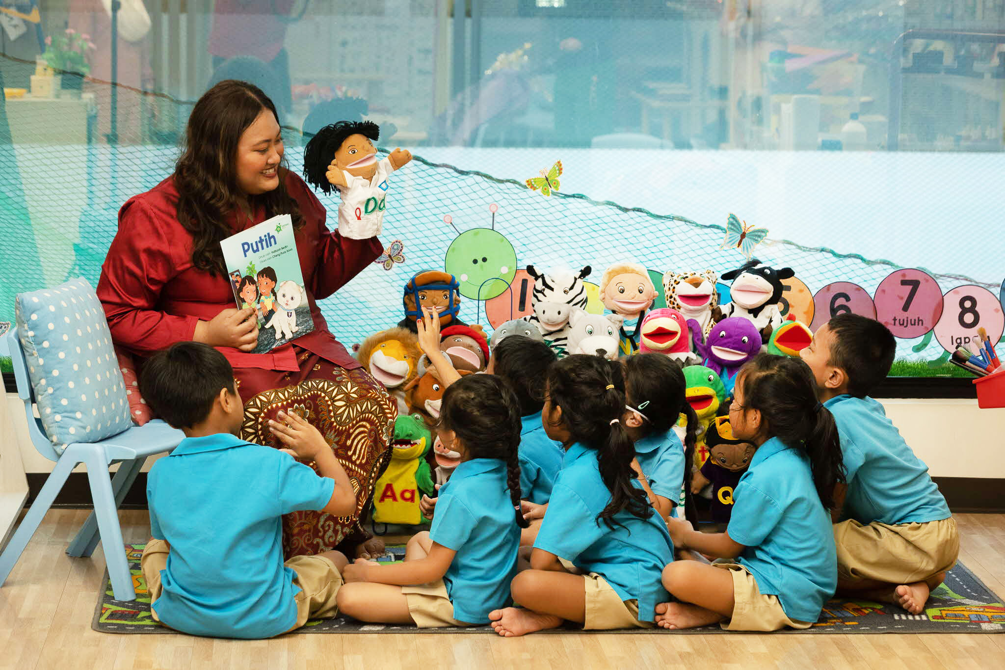 teacher reading to a class with a hand puppet