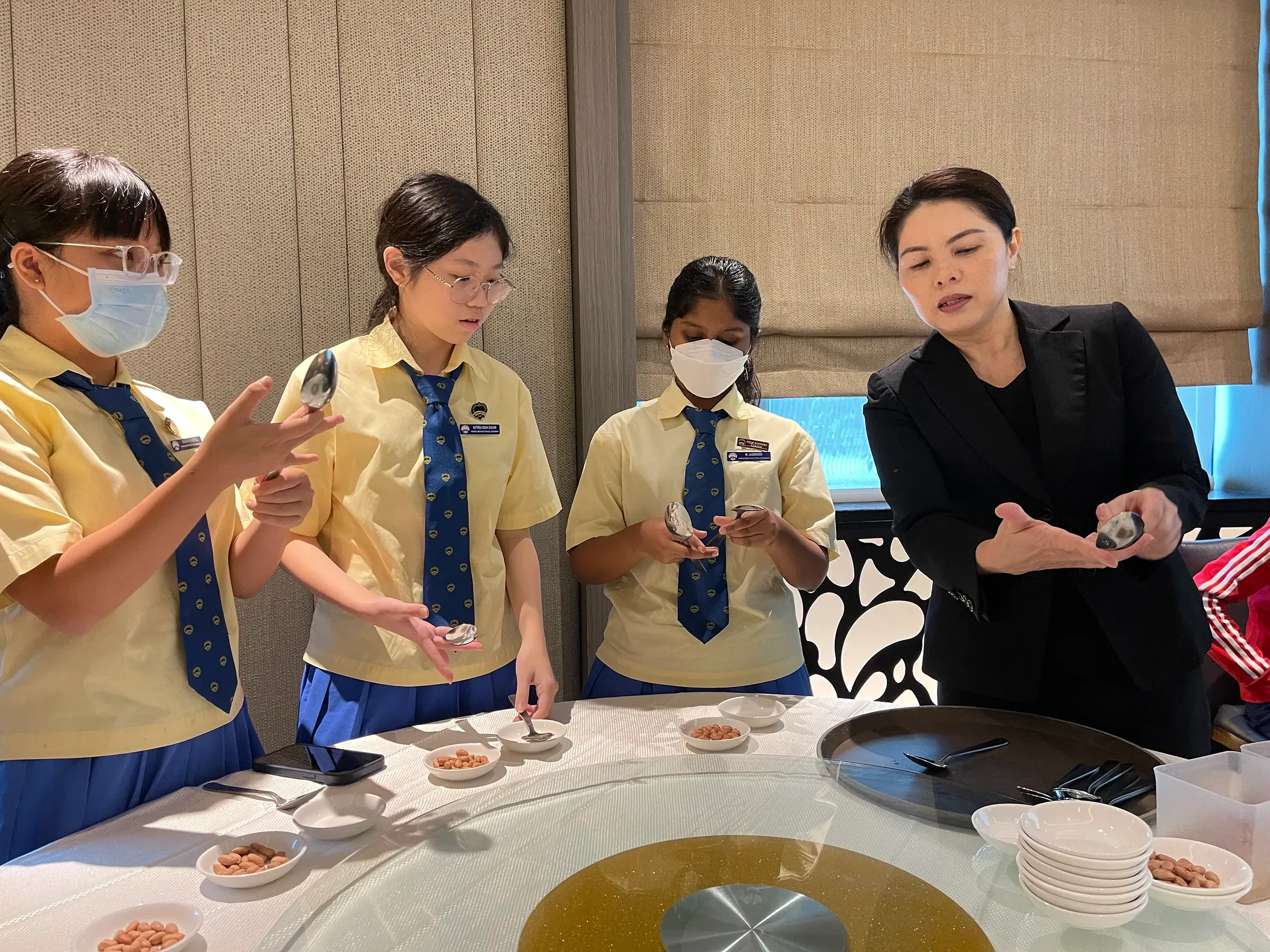 Students participating in a practical hospitality and social etiquette workshop at a restaurant during the 2023 learning festival.