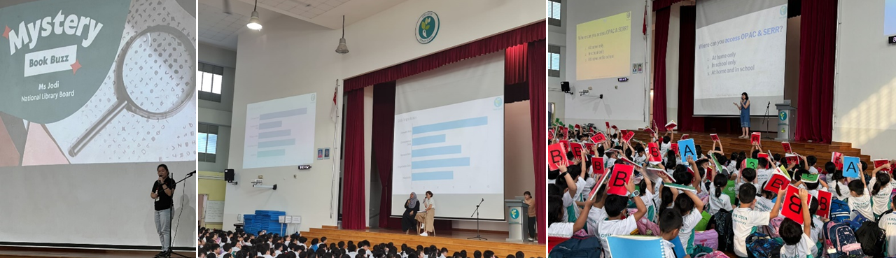 Students in a school hall attend a Mystery Book Buzz presentation, raising lettered cards while a speaker presents on stage.