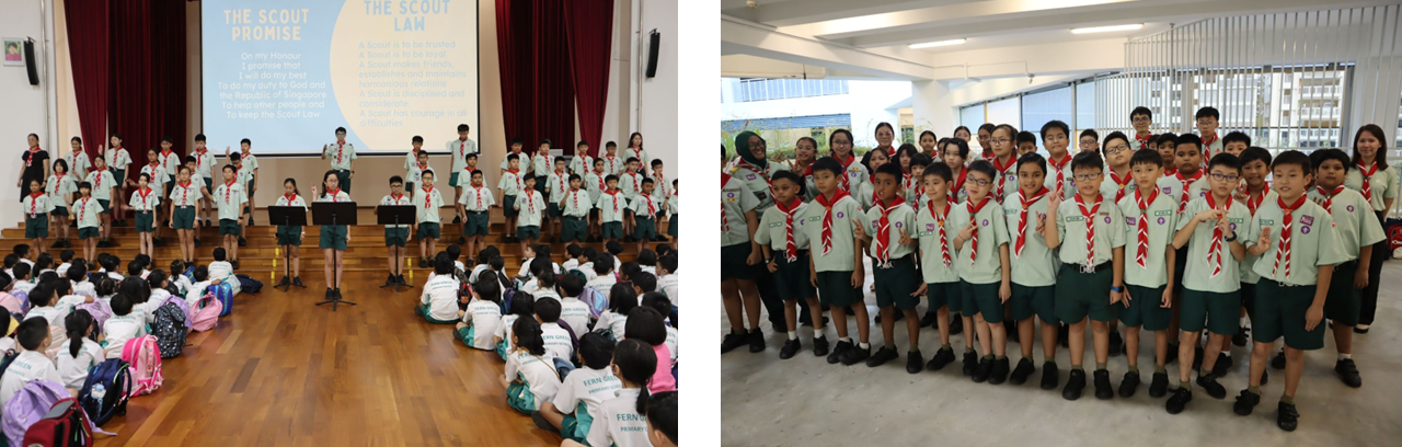 Students in scout uniforms with red neckerchiefs recite the Scout Promise on a stage while others sit and watch.