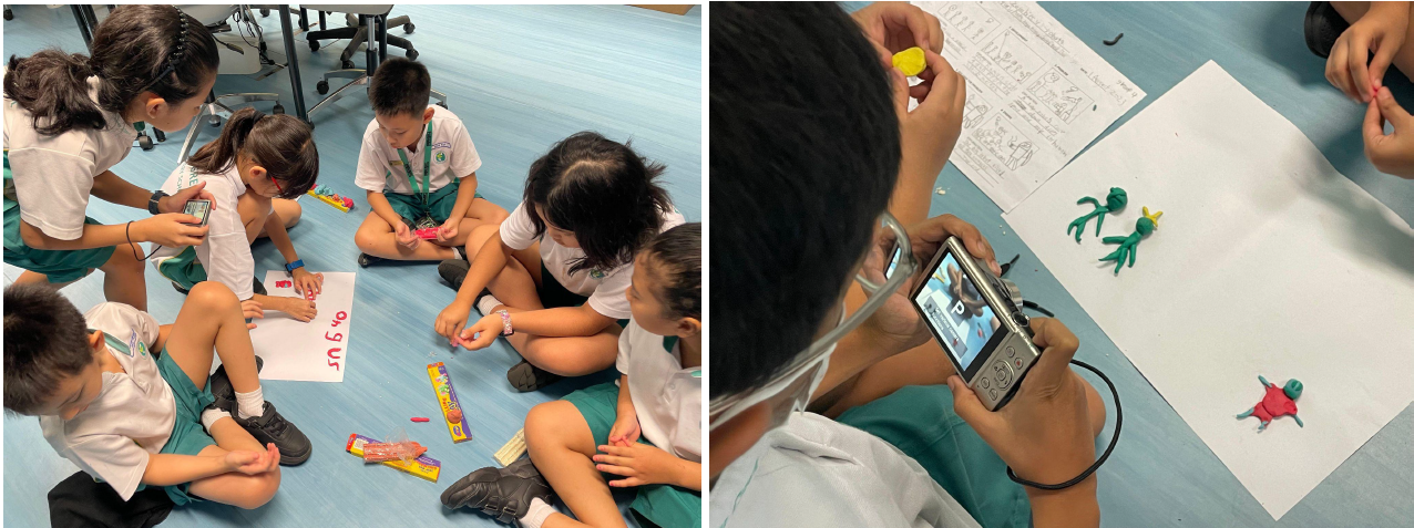 Children in school uniforms sit on a floor making clay figures, while one photographs small colorful clay animals with a camera.