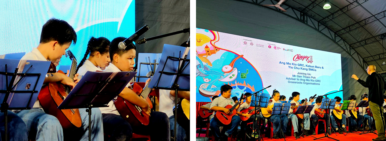 Children playing guitars on stage at a Chingay event, with a colorful backdrop screen displaying event details.