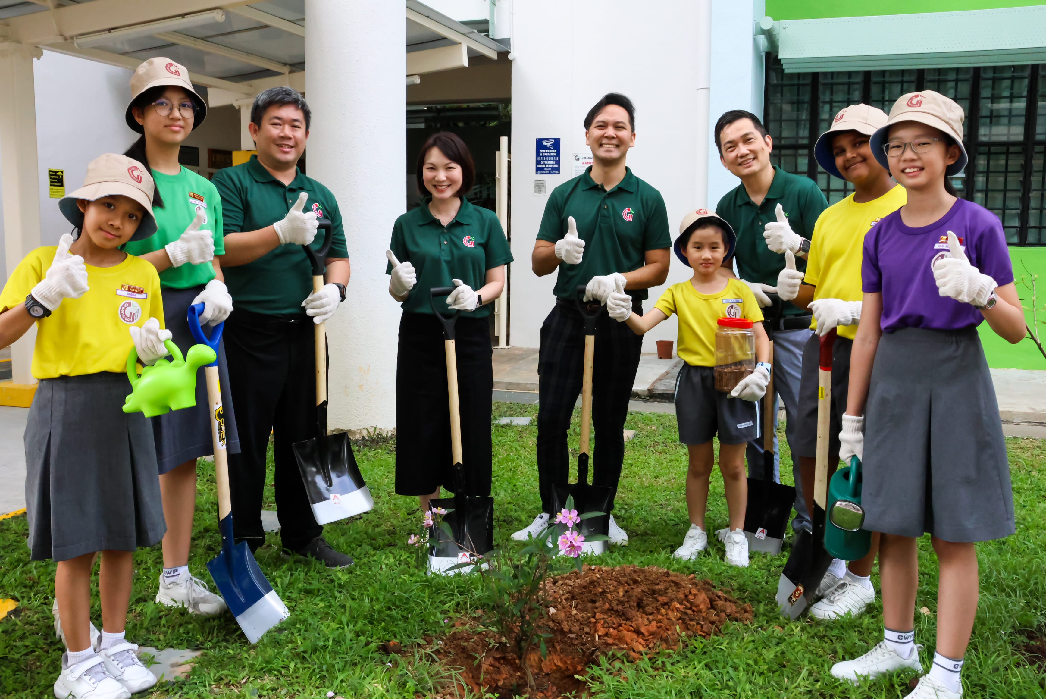 Students and School Leaders planting tree
