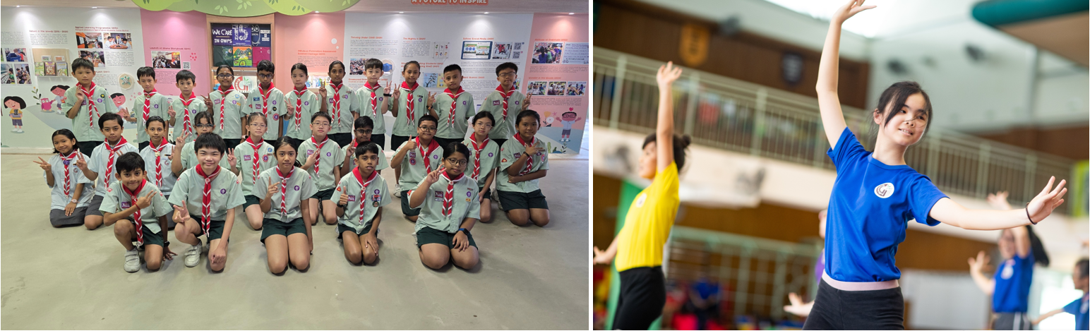 Group of students in scout uniforms posing, beside a girl in blue shirt dancing with arms raised in a gym.