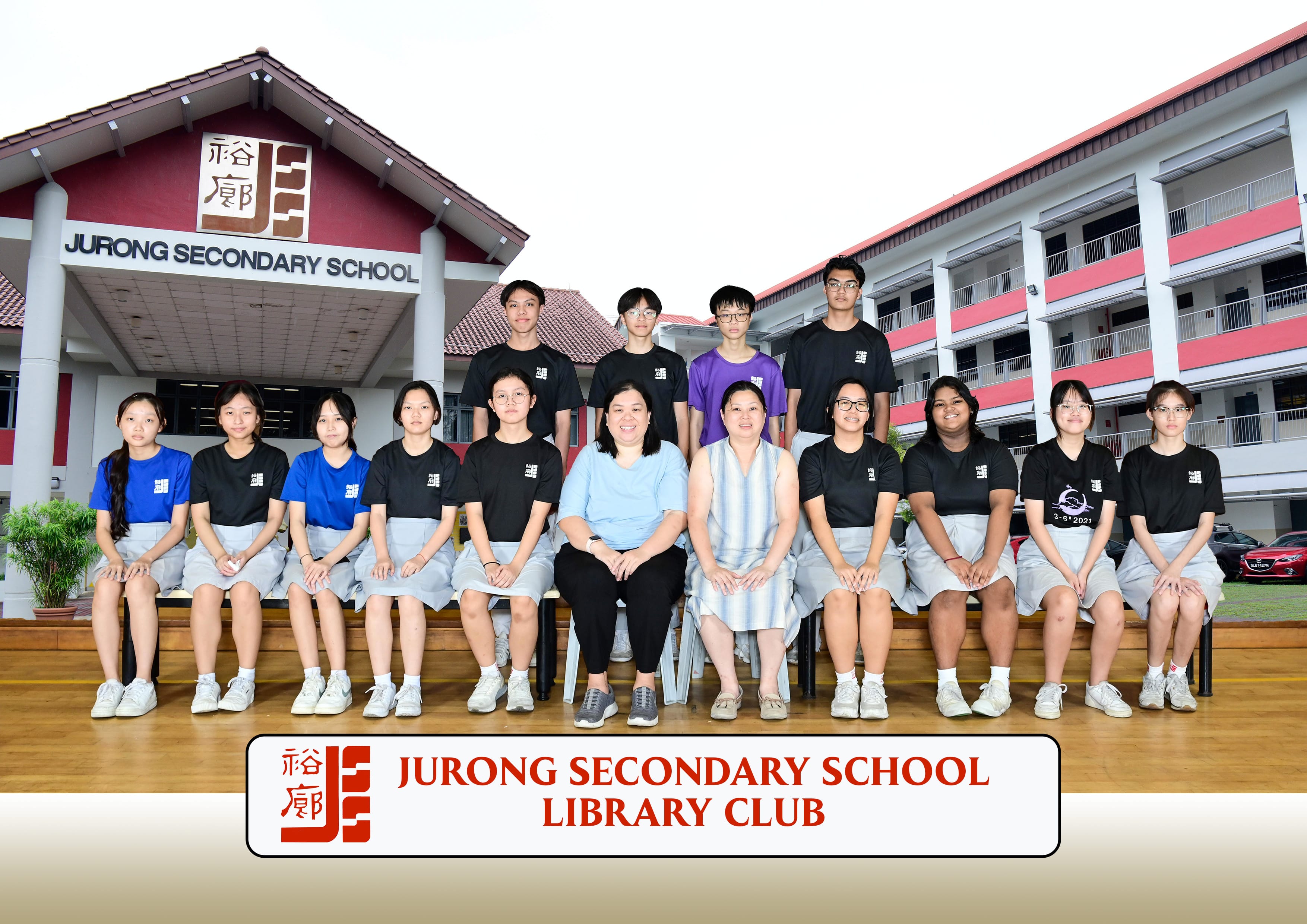 Group photo of Jurong Secondary School Library Club members and two teachers posed in front of the school building.