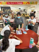 An interactive, hands-on workshop station organized and hosted by the Student Council in a communal school area during an enrichment program or campus festival.