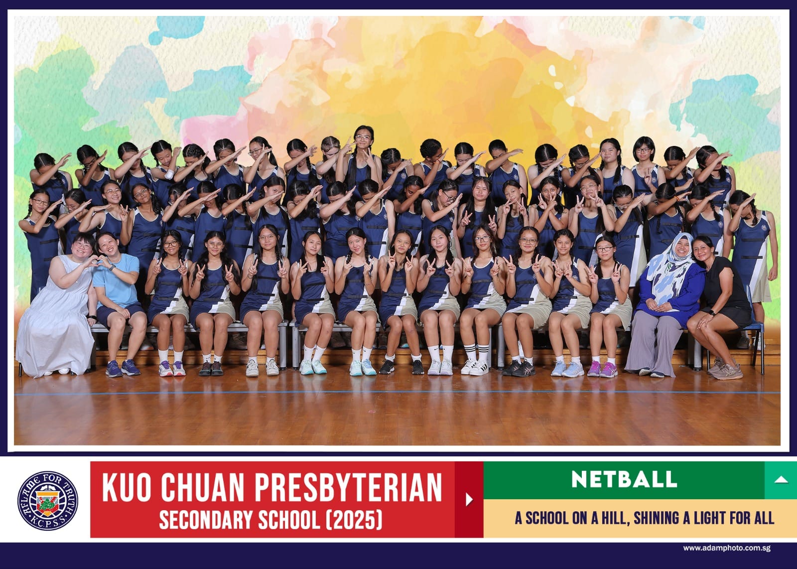 Group photo of Kuo Chuan Presbyterian Secondary School 2025 netball team in navy uniforms posing with teachers.