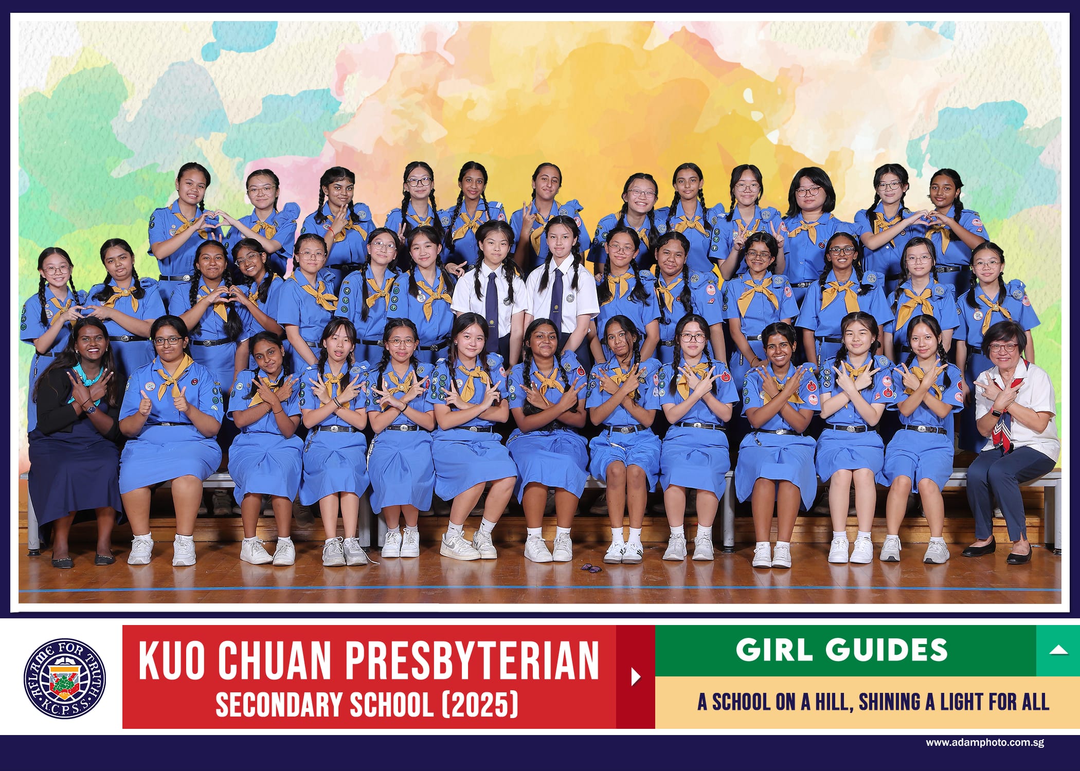 Group photo of Kuo Chuan Presbyterian Secondary School 2025 Girl Guides in blue uniforms with yellow scarves.