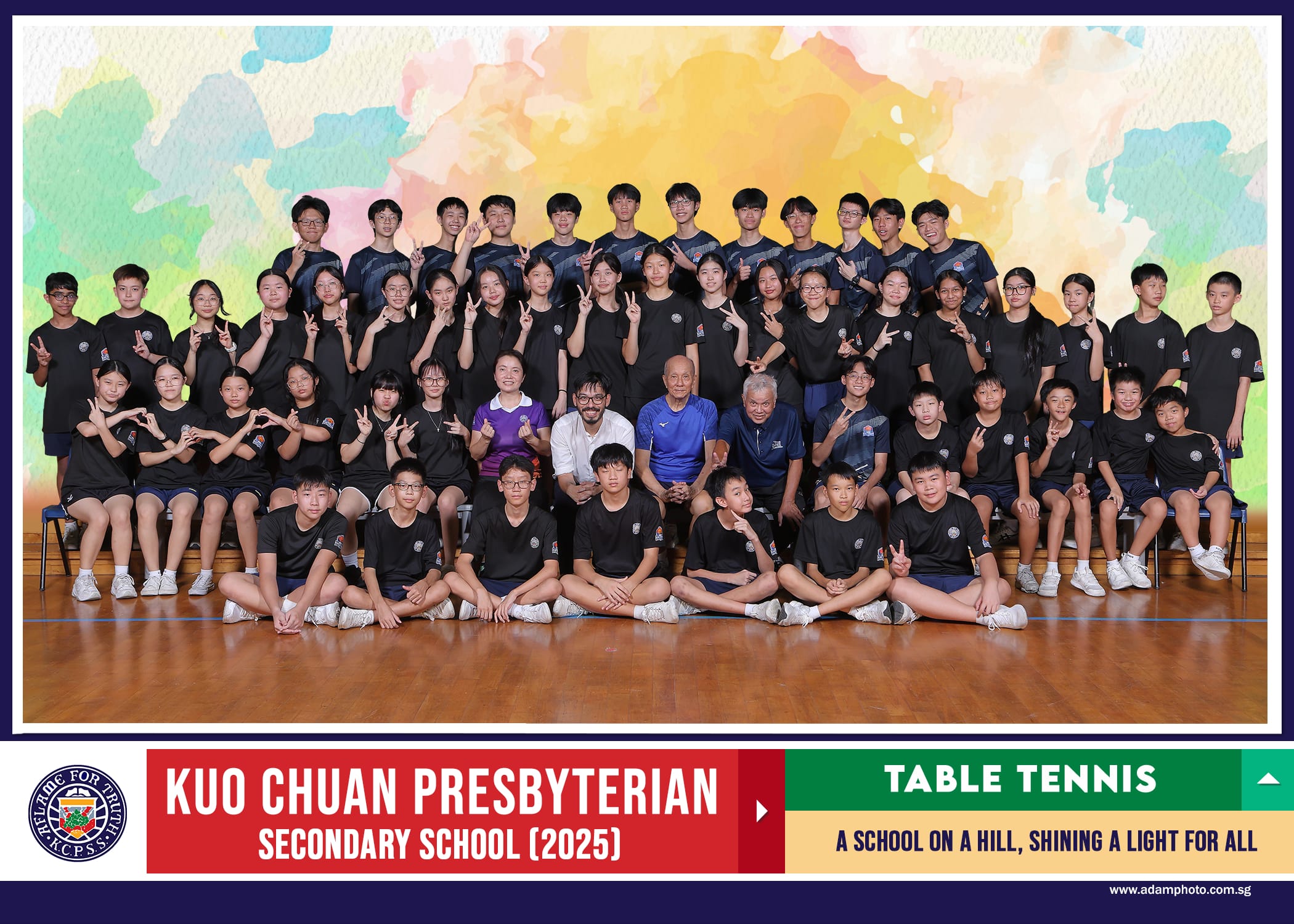 Group photo of Kuo Chuan Presbyterian Secondary School 2025 Table Tennis team posing in black uniforms indoors.
