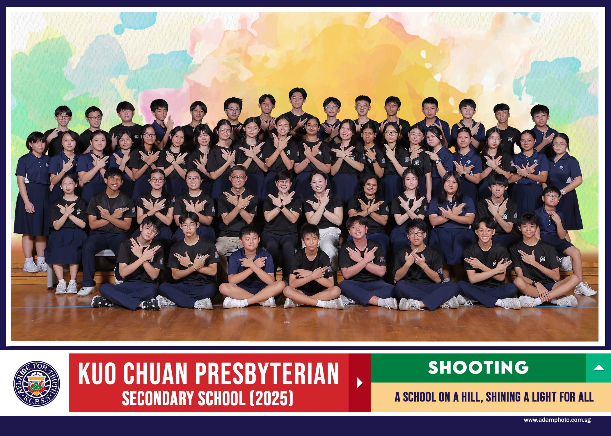 Group photo of Kuo Chuan Presbyterian Secondary School 2025 Shooting team posing in rows with crossed-arm gestures.