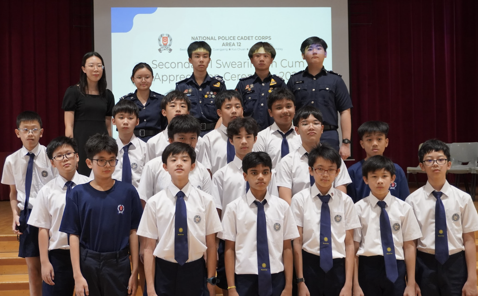 Group of students in school uniforms and police cadet uniforms posing at a National Police Cadet Corps Area 12 ceremony.