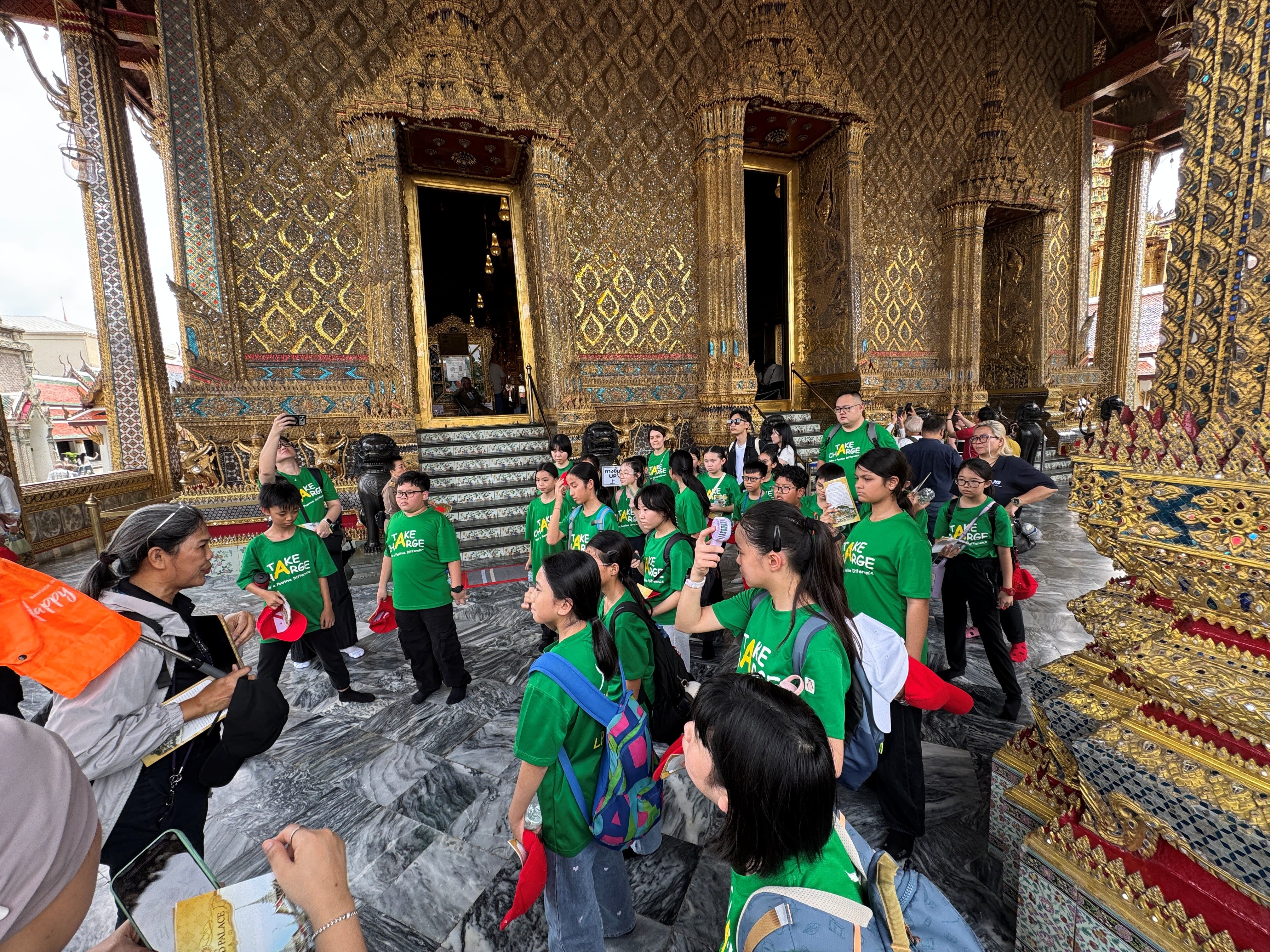 Students gather in front of a local guide as she explains to them about the history and culture of the place