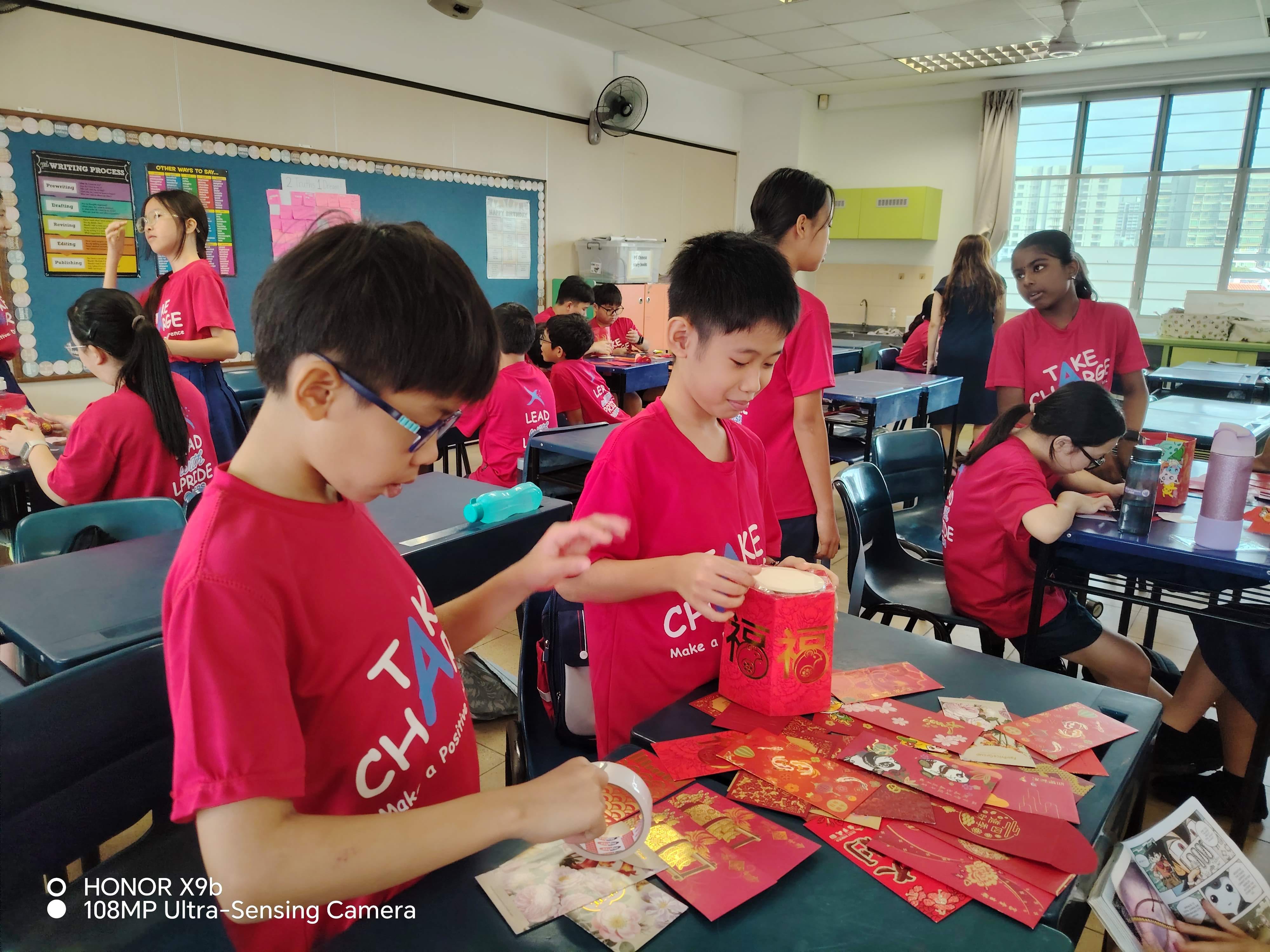 P6 students hard at work creating their handmade ang bao basket