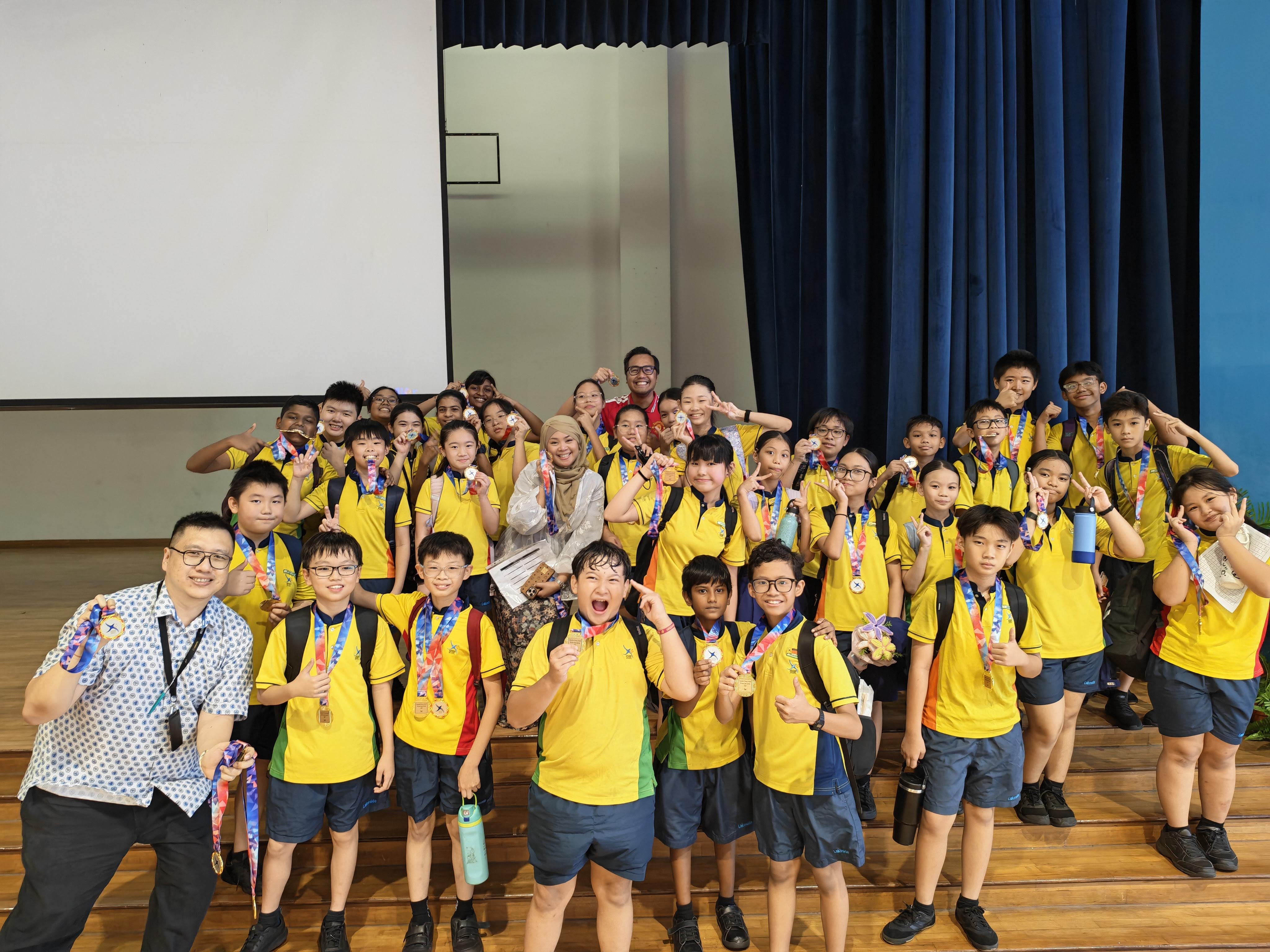 The class that emerged as the champions, P6 Integrity, poses for a group photo with their medals and their teachers