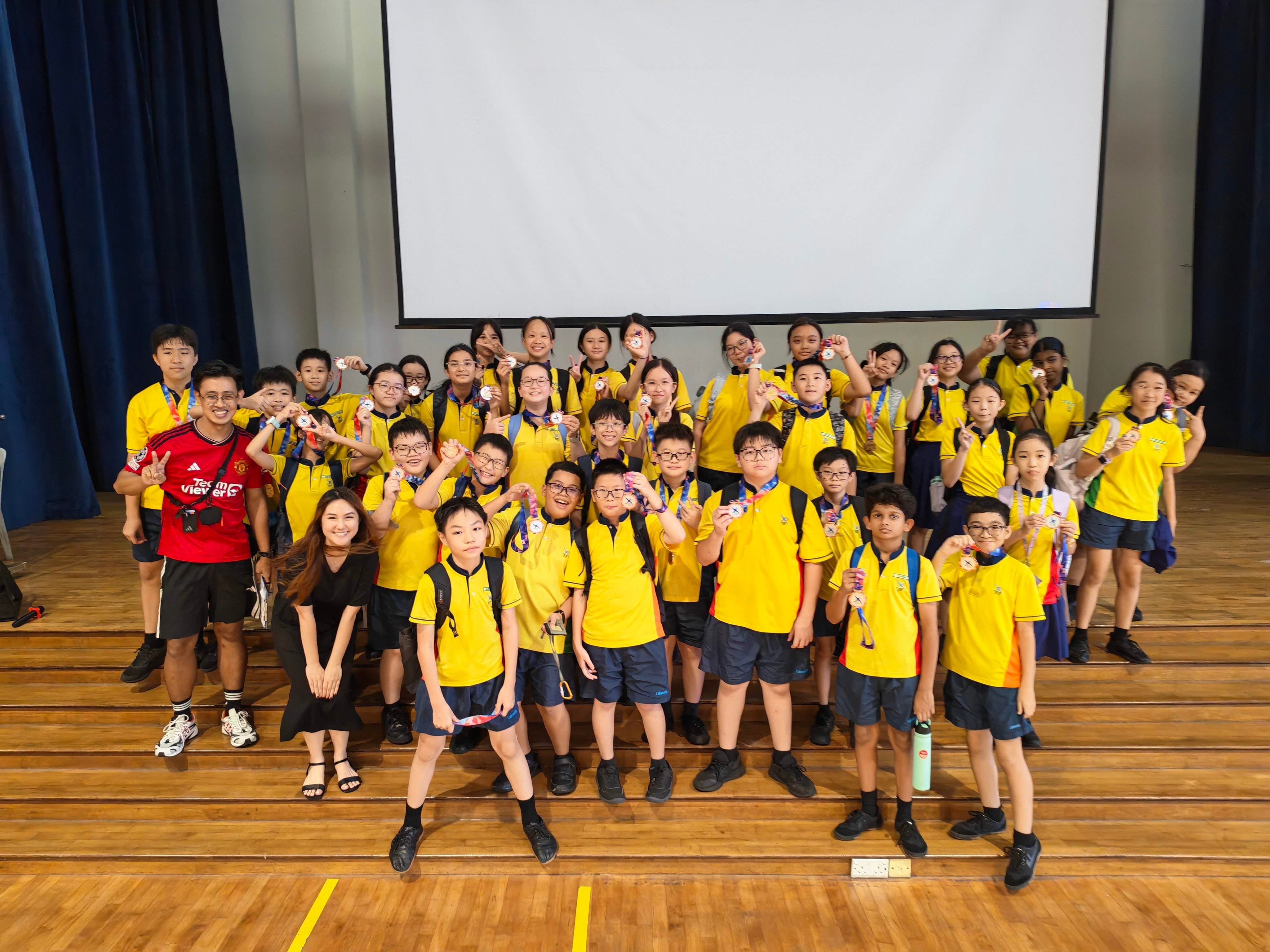 The class that won the 2nd Runner Up position, P6 Perserverance, poses for a group photo with their medals and their teacher