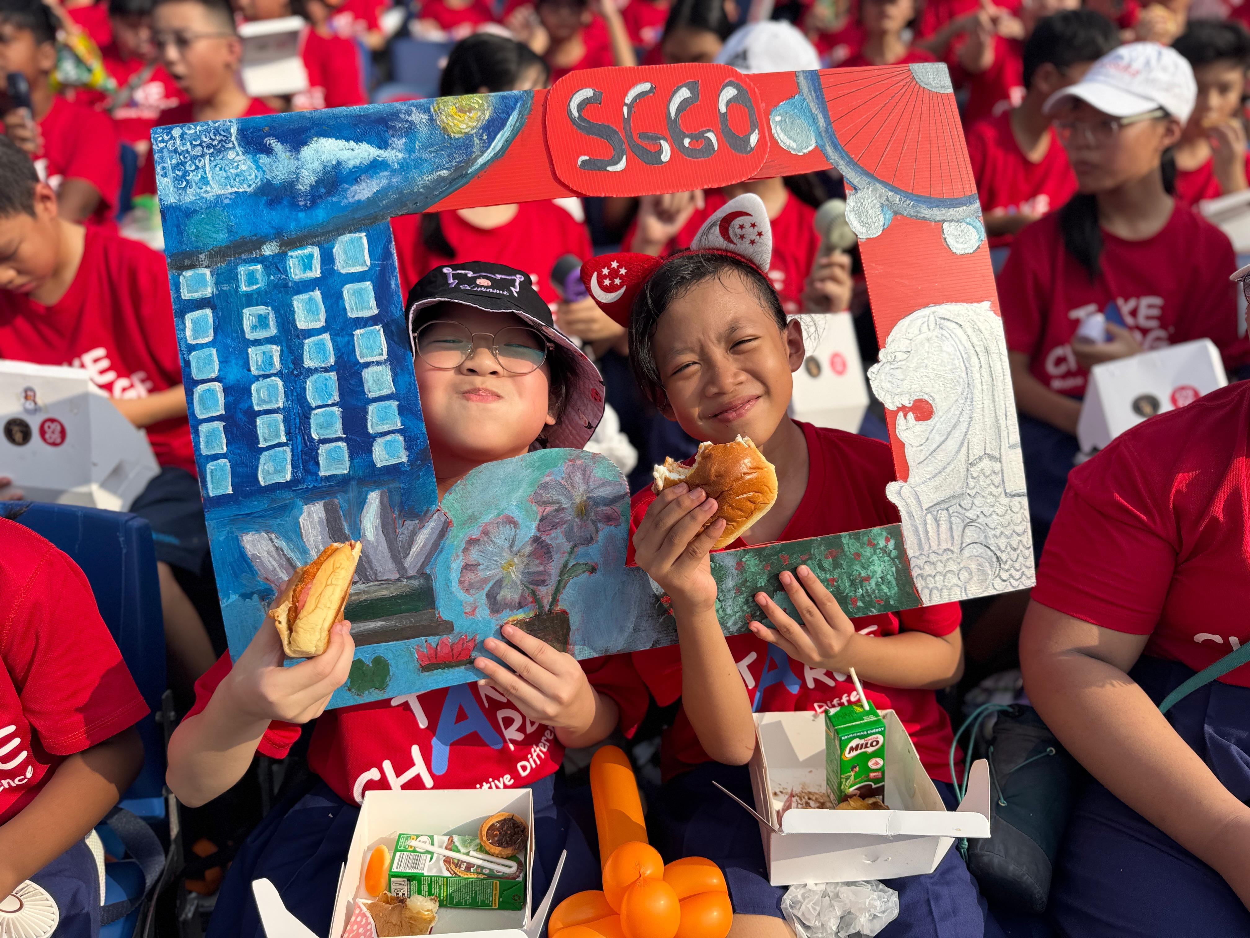 Our P5 students enjoying their refreshments as they eagerly awaited the start of the National Day Parade show
