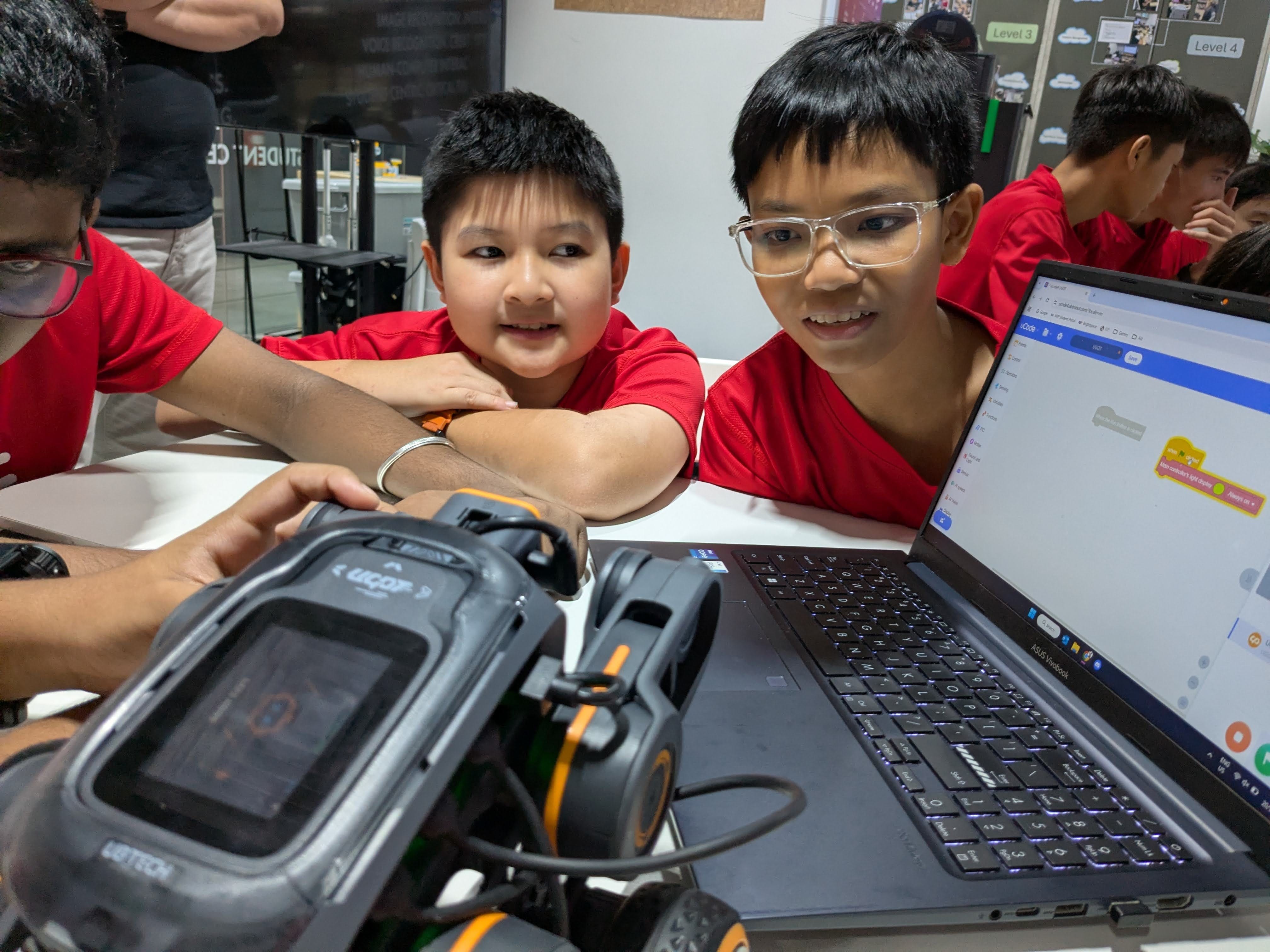 Students work together in groups to familiarise with the AI Bot and the coding platform