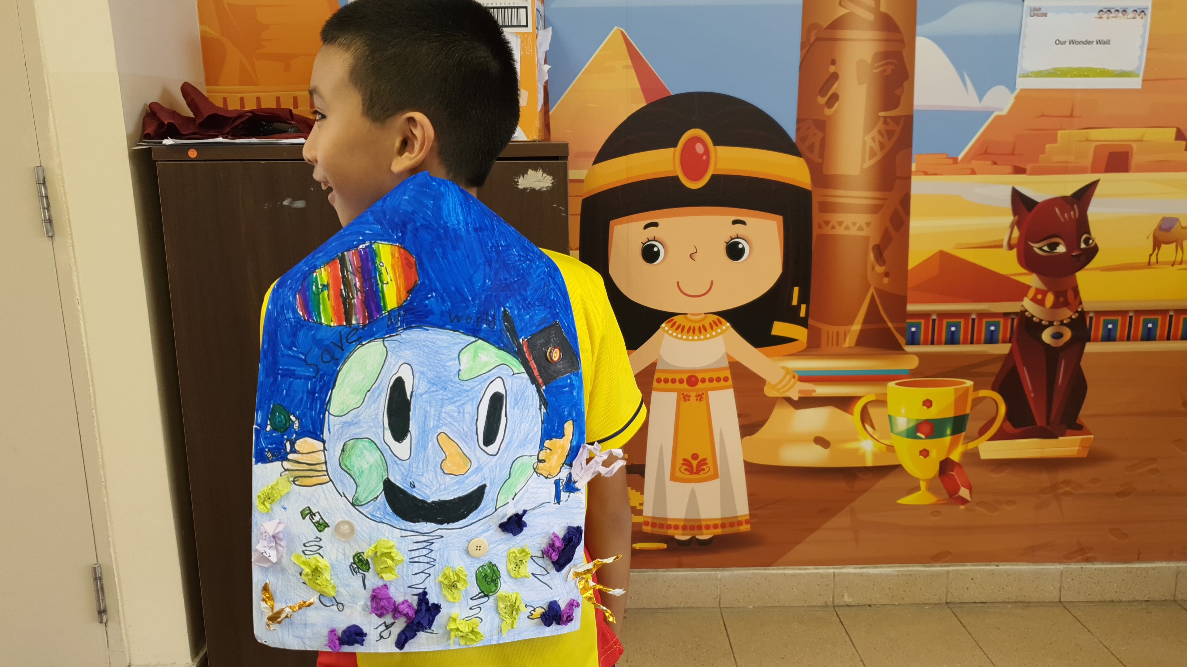 A student proudly showcasing his artwork.